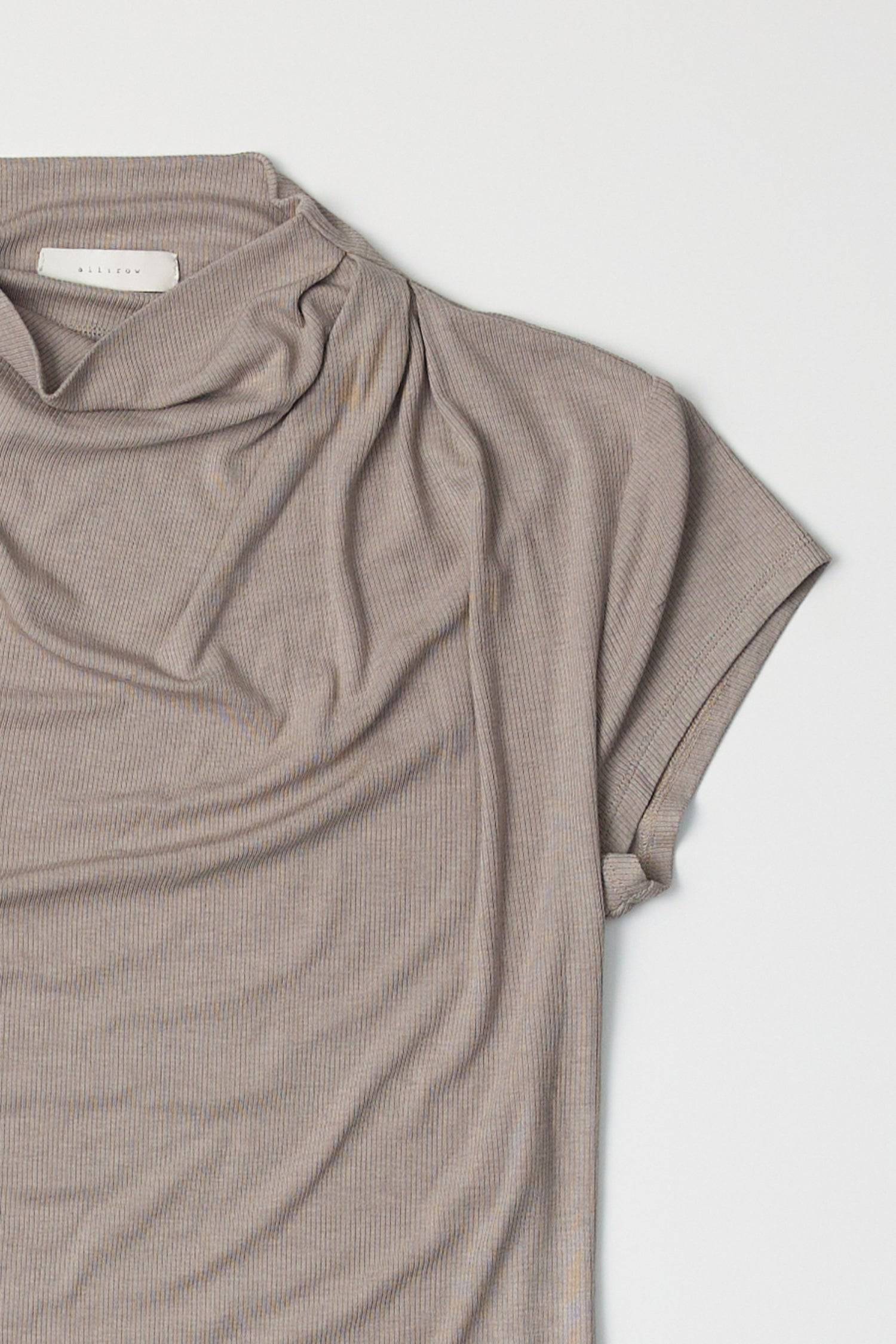 8994170470621, The Marissa Top, Tops, All Row, Cap Sleeve,Comfort,Comfortable,Cowl,cowl neck,Feminine,Form Fitting,Mock neck,new,Ribbed,Ribbed Fabric,Ribbed Top,Short Sleeve,Spring,Tops,versatile,white,Womens,womens top, Information The Marissa Top is a form-fitting ribbed knit top that features a mock cowl neck and subtle shoulder pleating for added texture. With cap sleeves and a sleek silhouette, it offers a modern, refined look. Details Self: 50% Modal, 35% Acrylic, 8% Wool, 7% Spandex Form Fitting Mock