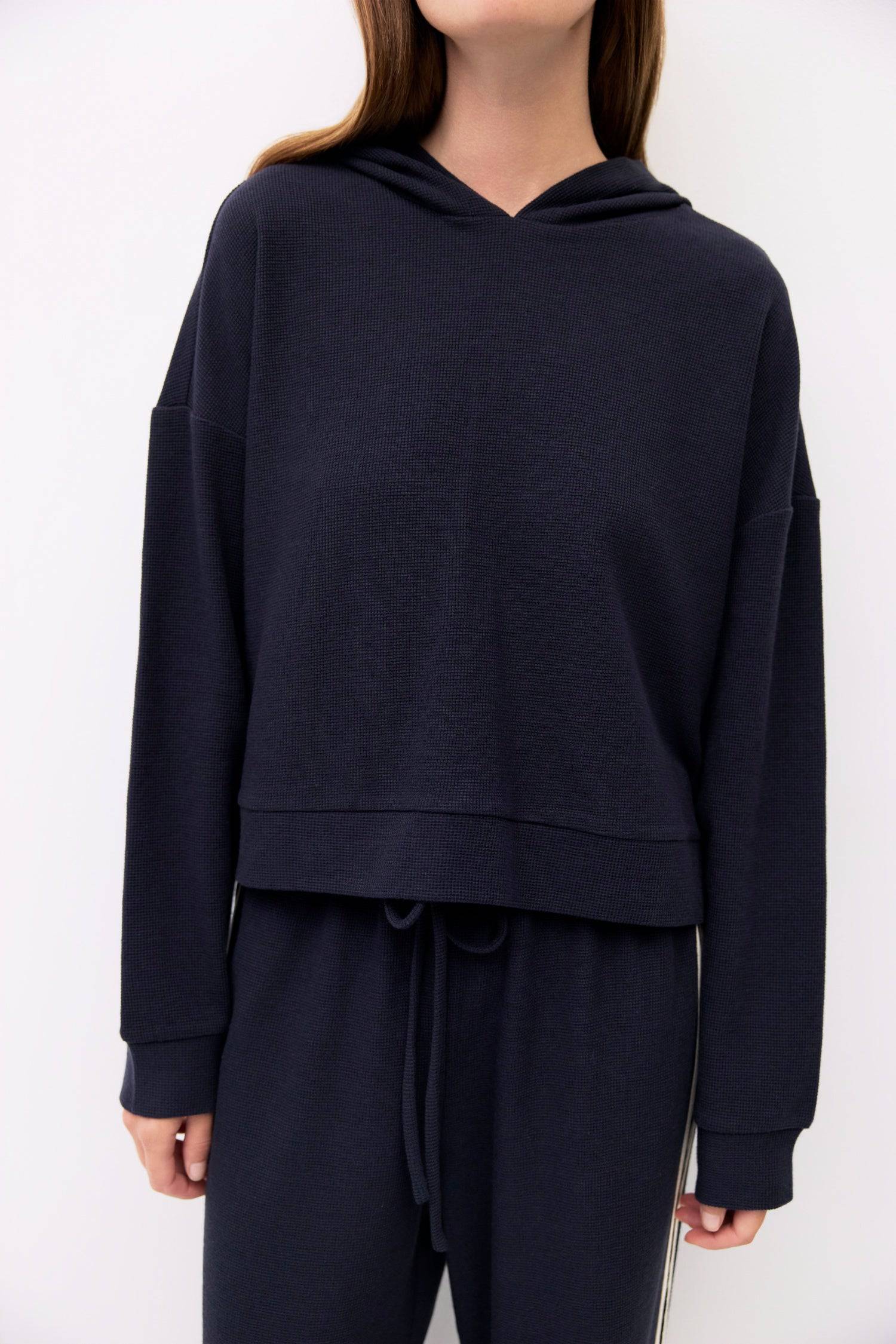 9084506472669, The Enzo Hoodie, Outerwear, All Row, All Row,allrow,Casual,cf-size-l,cf-size-m,cf-vendor-all-row,Cropped,cropped hemline,drop shoulder,Drop Shoulder Sleeve,Everyday,genderless,Hoodie,Minimal,minimalist,new,Outerwear,Polyester,Relaxed,Relaxed Fit,Ribbed,Ribbed Details,Ribbed Fabric,Spring,Sweater,Transitional,versatile,waffle knit,Womens,womens top, Information The Enzo Hoodie combines cozy midweight waffle knit with a relaxed fit and drop shoulders for effortless comfort. Finished with a hood