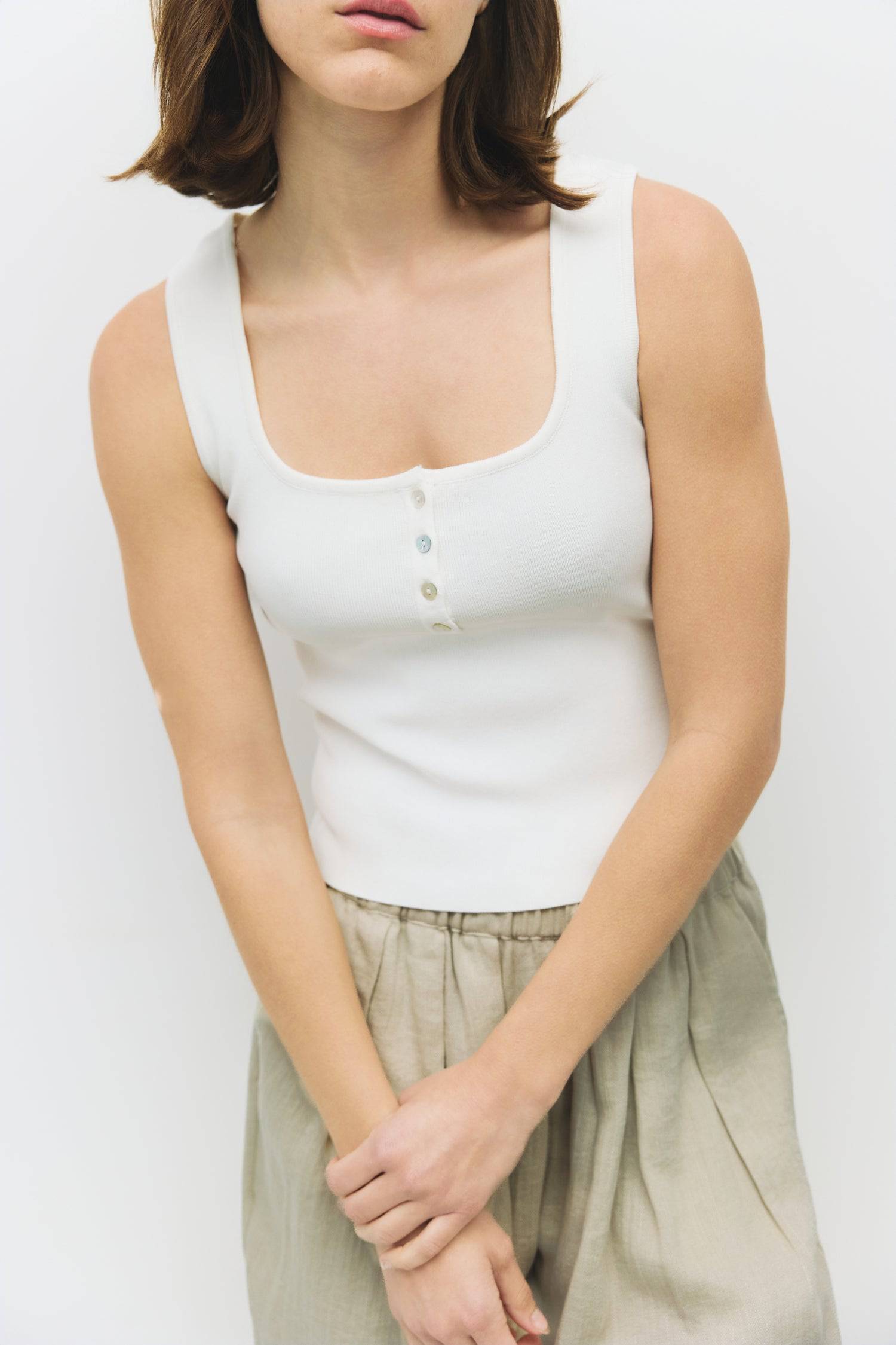 8929245593821, The Kerrigan Top, Tops, All Row, All Row,allrow,Basic,Basics,beige,Casual,cf-color-beige,cf-size-l,cf-size-m,cf-size-s,cf-vendor-all-row,Comfortable,Everyday,final-sale,finalsale,ivory,knit,Knit Top,Long Sleeve,Long Sleeve Top,Lounge,Loungewear,new,sale,Sleevless,Spring,Summer,tank,thin,Women's,womens top, Information The Kerrigan Top is a simple sleeveless tank featuring a square neckline and a partial button-down front for a touch of flair. Made from a soft ribbed knit fabric, this top is p