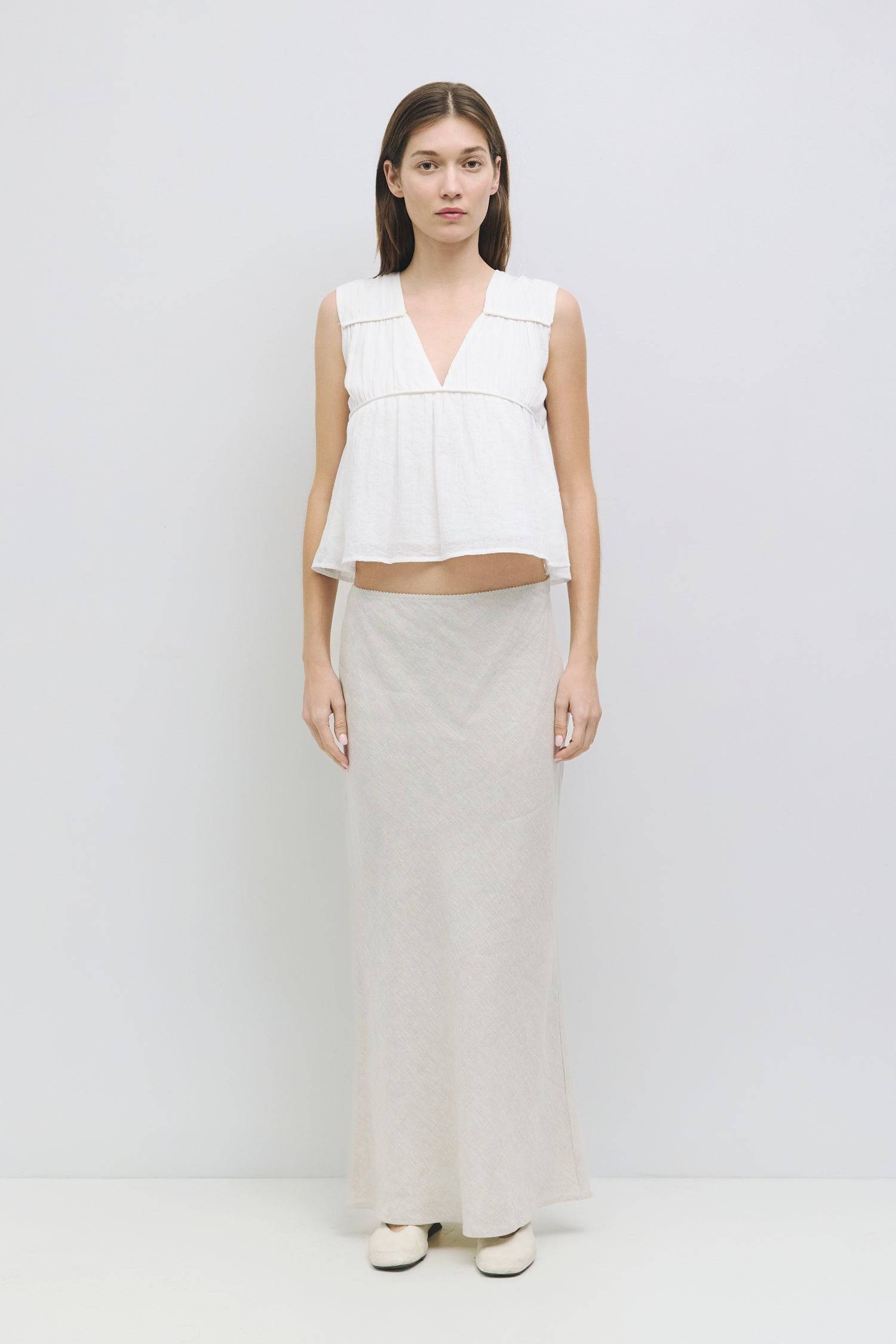 9045682553053, The Cora Top, Tops, Mod Ref, Basic,Basics,Black,boat neck,Casual,cf-color-black,cf-size-l,cf-size-m,cf-size-s,cf-vendor-mod-ref,Comfortable,Everyday,panel,Ribbed Top,Sleeveless,Spring,Summer,Tee,Tops,Transitional,V Neckline,white,Women's,womens top, Information The Cora Top is a sleeveless blouse with paneled shirring that creates a flattering silhouette. Its v-neckline adds a touch of elegance and effortlessly pairs with a midi skirt or high-waisted bottoms. Details 100% Cotton Gathered V Ne