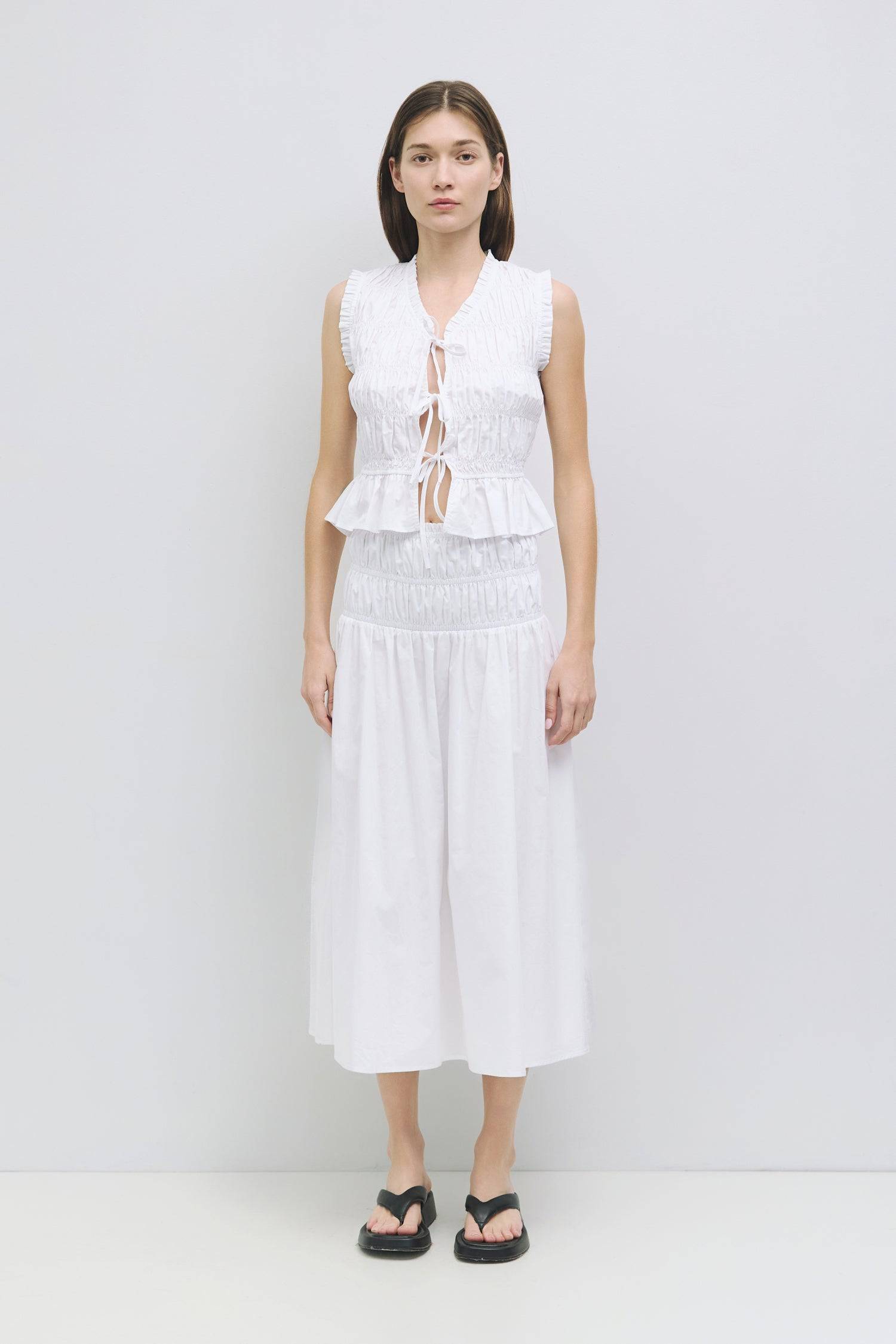 8929244872925, The Natasha Top, Tops, All Row, All Row,allrow,Black,Casual,cf-color-black,cf-color-white,cf-color-yellow,cf-size-l,cf-size-m,cf-size-s,cf-vendor-all-row,cinched,front ties,Long Sleeve,Long Sleeve Top,Matching Set,new,Ruffles,set,Sets,Spring,Summer,texture,white,Women's,womens top,Yellow, Information The Natasha Top is a charming sleeveless top with a V-neckline and front tie detailing. Featuring paneled shirring and ruffle accents around the neckline and sleeves, this top adds a playful touc