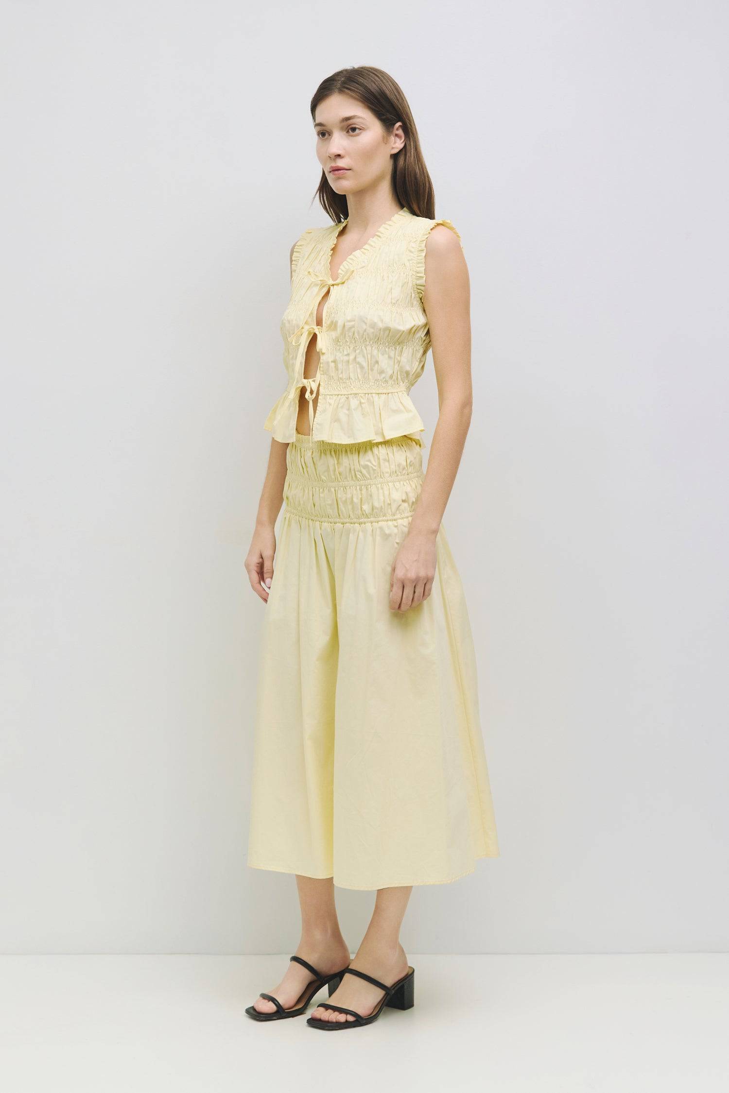 8929244872925, The Natasha Top, Tops, All Row, All Row,allrow,Black,Casual,cf-color-black,cf-color-white,cf-color-yellow,cf-size-l,cf-size-m,cf-size-s,cf-vendor-all-row,cinched,front ties,Long Sleeve,Long Sleeve Top,Matching Set,new,Ruffles,set,Sets,Spring,Summer,texture,white,Women's,womens top,Yellow, Information The Natasha Top is a charming sleeveless top with a V-neckline and front tie detailing. Featuring paneled shirring and ruffle accents around the neckline and sleeves, this top adds a playful touc