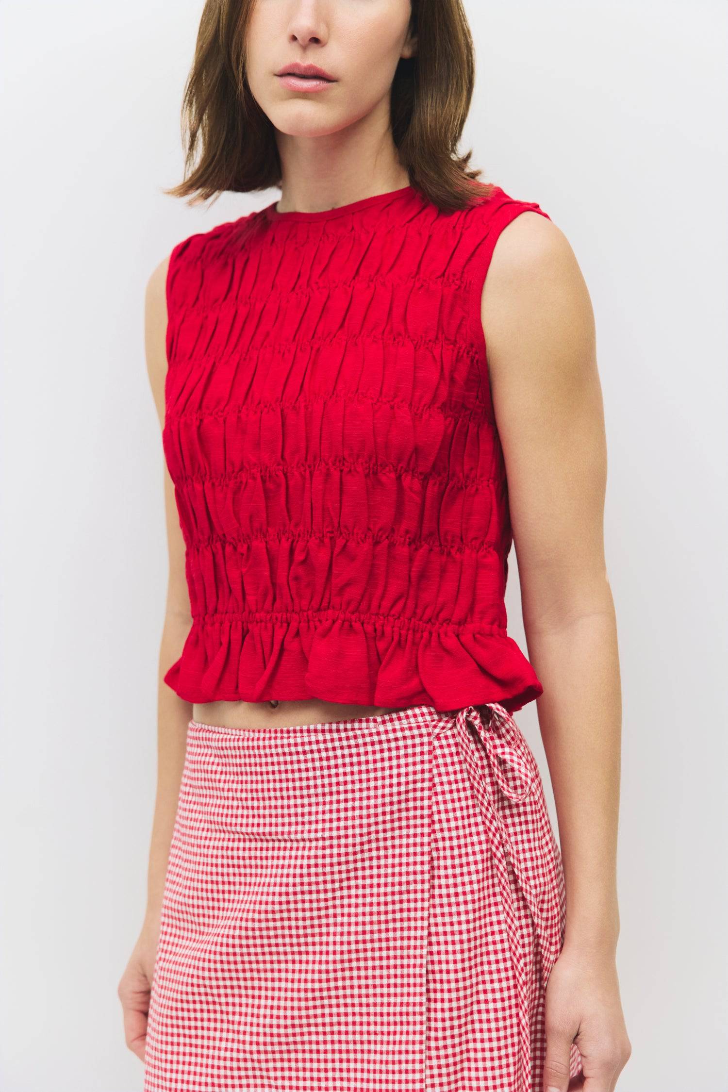 8954058146013, The Florencia Top, Tops, All Row, All Row,allrow,Black,Casual,cf-color-black,cf-color-white,cf-color-yellow,cf-size-l,cf-size-m,cf-size-s,cf-vendor-all-row,cinched,final-sale,finalsale,new,Red,Ruffles,sale,set,Sets,Spring,Summer,texture,white,Women's,womens top, Information The Florencia Top is a sleeveless smocked linen piece with a high neck and a keyhole back with a button closure. Its smocked front and back, plus a playful bottom ruffle, create a relaxed, cropped fit that’s perfect for th