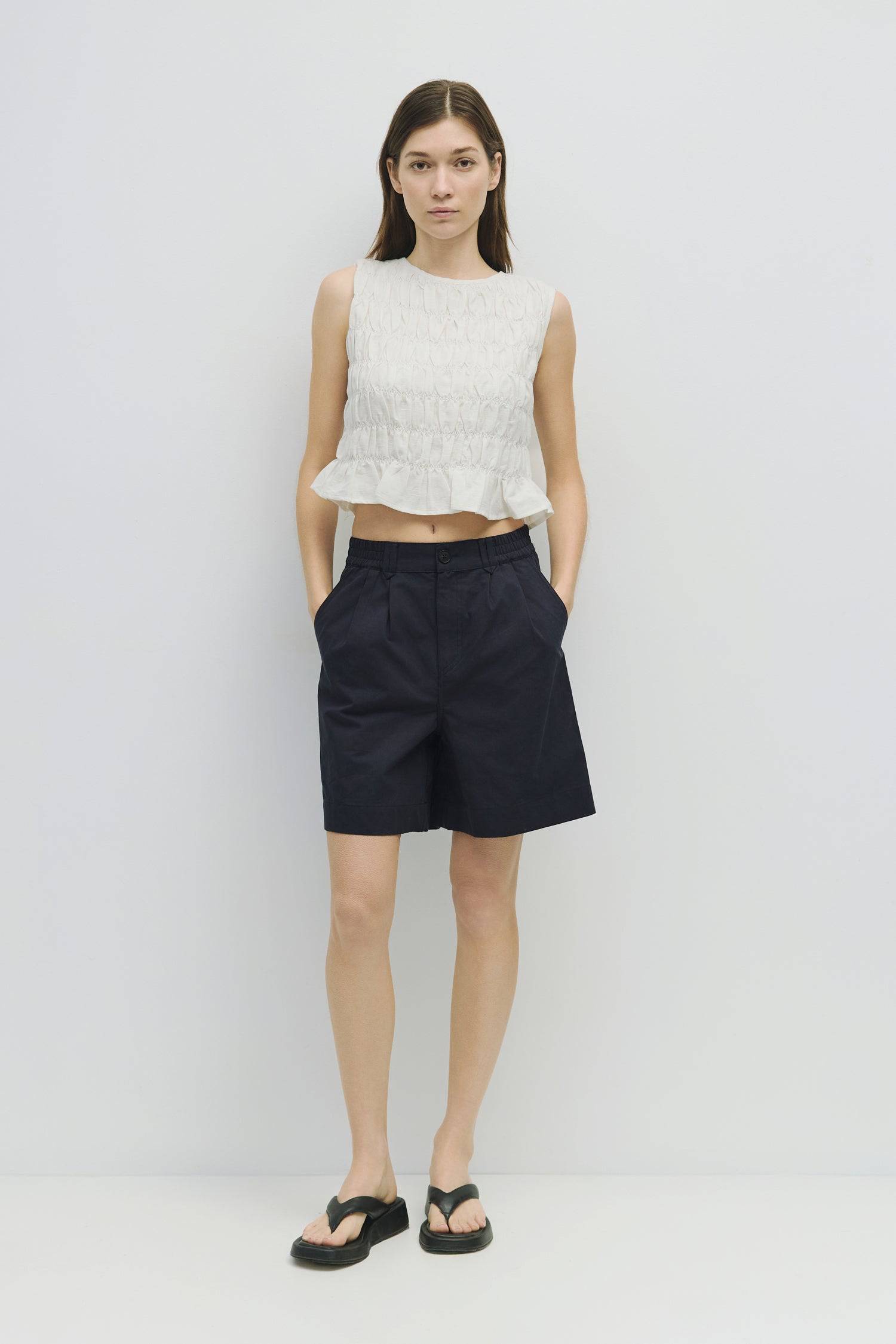 8954058146013, The Florencia Top, Tops, All Row, All Row,allrow,Black,Casual,cf-color-black,cf-color-white,cf-color-yellow,cf-size-l,cf-size-m,cf-size-s,cf-vendor-all-row,cinched,final-sale,finalsale,new,Red,Ruffles,sale,set,Sets,Spring,Summer,texture,white,Women's,womens top, Information The Florencia Top is a sleeveless smocked linen piece with a high neck and a keyhole back with a button closure. Its smocked front and back, plus a playful bottom ruffle, create a relaxed, cropped fit that’s perfect for th