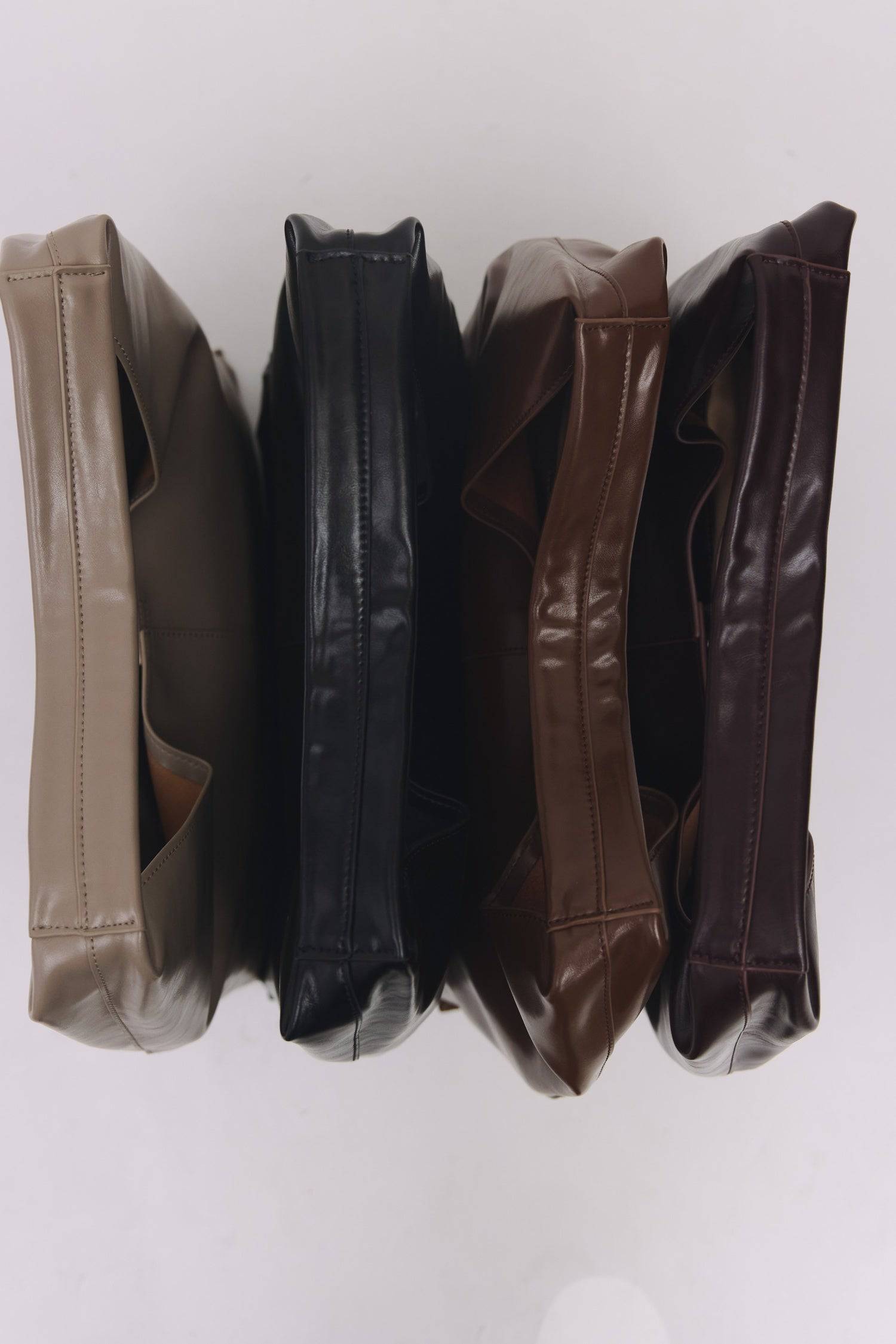 8989083599069, The Cosani Bag, Bags, Mod Ref | Common Market, accessories,bag,bags,cf-color-khaki,cf-color-white,cf-vendor-mod-ref-common-market,dark brown,modrefcommonmarket,Oversized,purse, Information The Cosani Bag is a medium-sized, slouchy patent leather bindle bag with a front seam detail and integrated patent strap. Features a magnetic button closure, flat bottom for structure, and a removable makeup or coin purse for added convenience. Details 100% Cowhide Slouchy Shape Magnetic Button Closure Remo