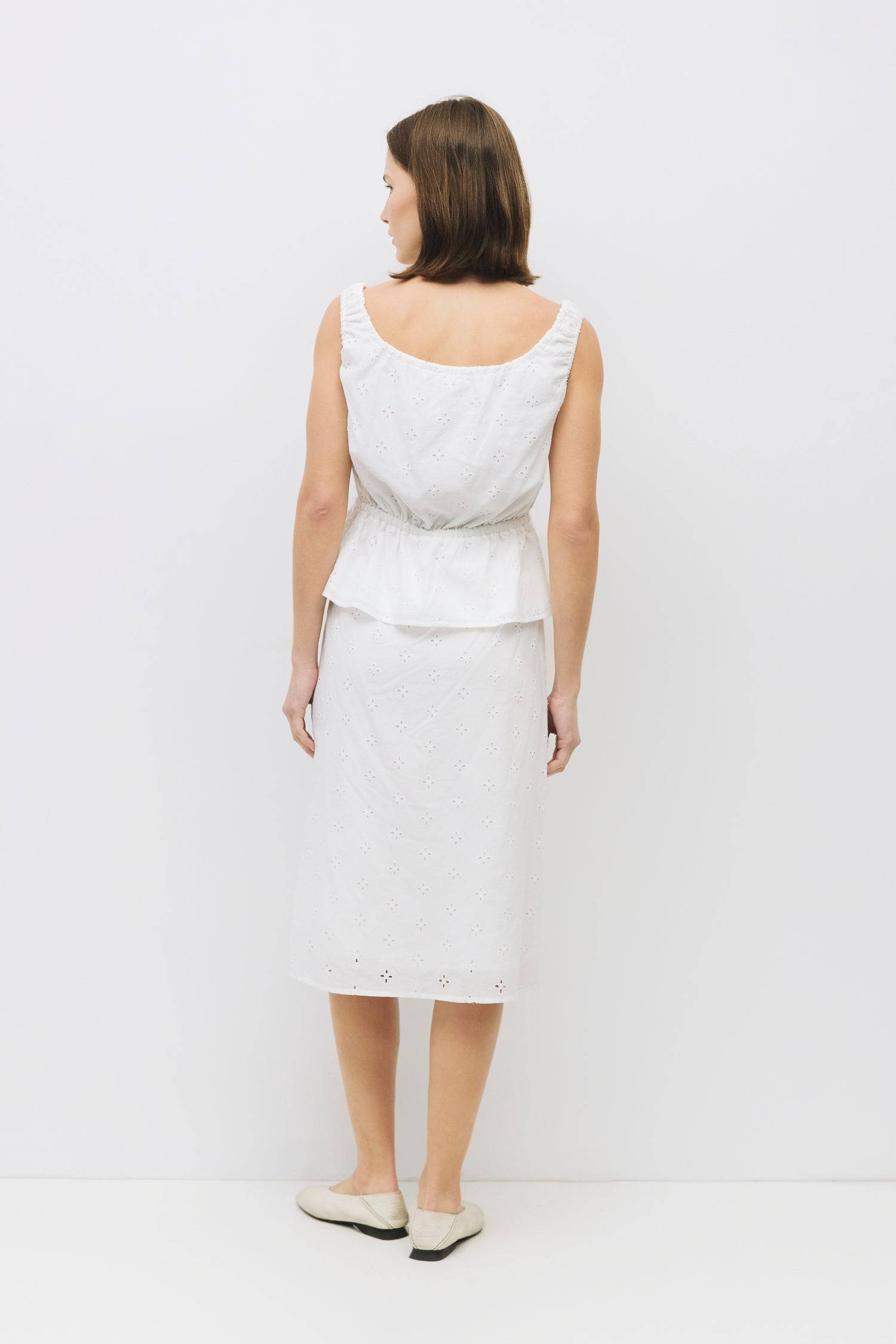 8983733043421, The Kristina Top, Tops, All Row, 90s,Basic,Basics,Black,Blue,Casual,cf-color-black,cf-color-blue,cf-color-white,cf-size-l,cf-size-m,cf-size-s,cf-vendor-mod-ref,Comfortable,Crew Neck,Crew Neckline,Everyday,Form Fitting,Ribbed,Ribbed Fabric,Ribbed Top,Short Sleeve,Spring,stretch,Stretchy,Summer,Tee,Tops,Transitional,white,Women's, Information The Kristina Top is a sleeveless cotton eyelet piece featuring a gathered neckline and adjustable ties for a custom fit. With an elasticized waist and ful