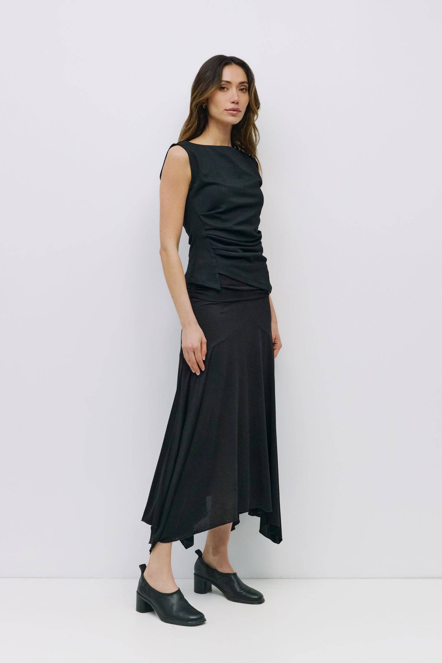 8999198523613, The Alaina Top, Tops, Mod Ref, 90s,asymmetrical,Basic,Basics,Black,Blue,boat neck,boat neckline,Casual,cf-color-black,cf-color-cream,cf-size-l,cf-size-m,cf-size-s,cf-vendor-mod-ref,Comfortable,Cream,Everyday,Form Fitting,Ribbed Fabric,Ribbed Top,Short Sleeve,Spring,stretch,Stretchy,Summer,Tee,Tops,Transitional,white,Women's, Information The Alaina Top is a sleek knit tank with a refined boatneck and an asymmetrical hem for a modern edge. The side pleats and back seams create a fitted silhouet