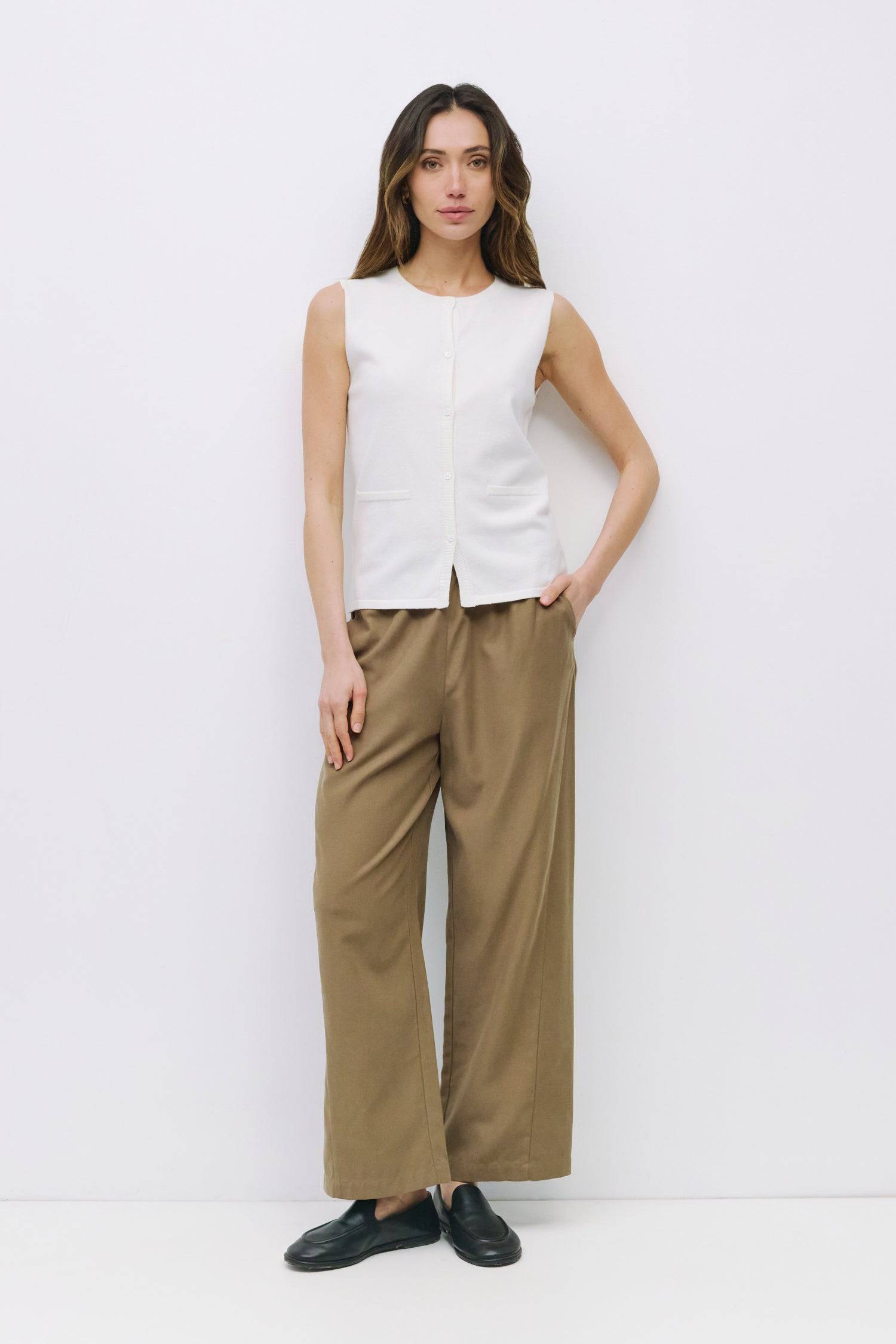 9023144493277, The Dominique Top, Tops, Mod Ref, Basic,Basics,Black,Button Front,Button up,Buttons,Cardigan,Casual,cf-color-black,cf-size-l,cf-size-m,cf-size-s,cf-size-xl,cf-vendor-mod-ref,Everyday,Knit,Mod Ref,modref,new,Relaxed,Relaxed Fit,Sets,Sleeveless,Sleeveless Top,Soft Knit,Transitional,white,Women's, Information The Dominique Top is a fitted sleeveless knit vest with a ribbed neckline and front placket. Detailed with pearl button closures, it effortlessly blends a polished look with the comfort of