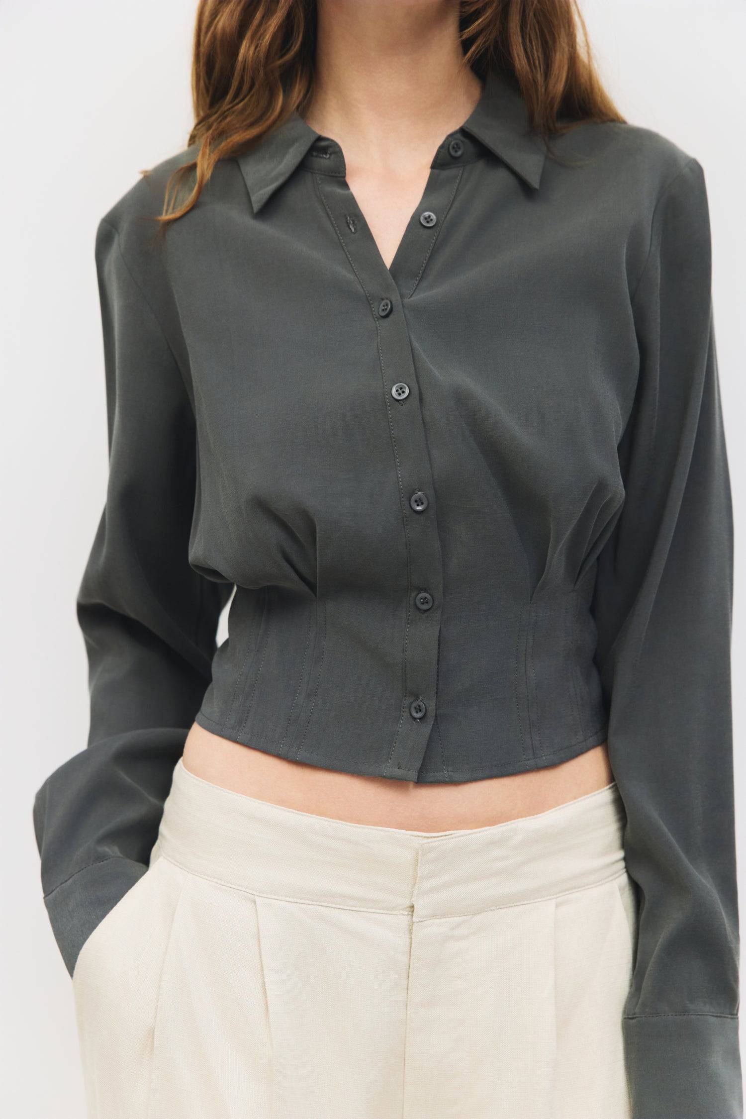 9084452274397, The Violeta Top, Tops, Mod Ref, Blouse,Breathable,Button down,Button Down Shirt,Button Up,Casual,cf-color-grey,cf-color-white,cf-size-l,cf-size-m,cf-size-s,cf-vendor-mod-ref,cinched,Cinched Back,Cinched Waist,collared,Collared Top,Cropped,cropped hemline,everyday,Grey,Long Sleeve,Long Sleeve Top,new,Pleated,Silk,Silky,slim fit,spring,Tapered,Tops,white,womens,Work,Workwear, Information The Violeta Top is a slim-fit button-down blouse with a collared neckline and long sleeves. It features a ta