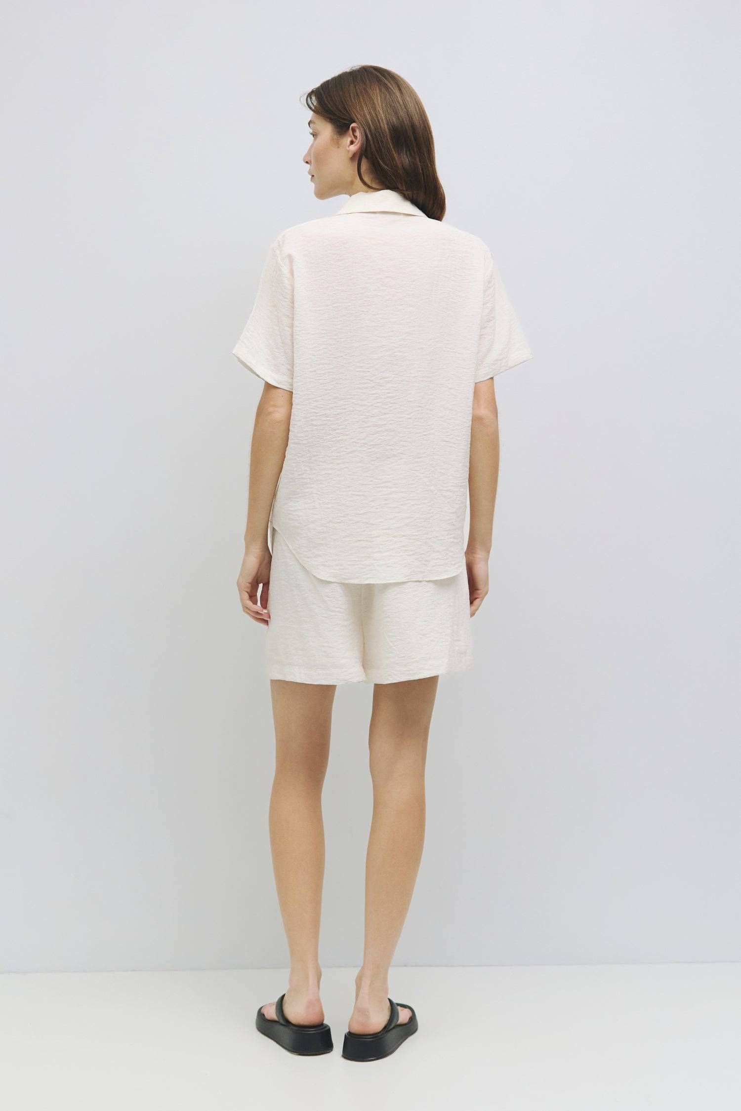 8954054279389, The Alden Top, Tops, Mod Ref, Black,Button Up,Casual,cf-color-black,cf-color-cream,cf-size-l,cf-size-m,cf-size-s,cf-vendor-all-row,cinched,Cream,Cropped,cropped hemline,final-sale,finalsale,Front Tie,Mod Ref,new,Olive,sale,Short Sleeve,Spring,Summer,white,Women's,womens top, Information The Alden Top is a short-sleeve, button-down shirt with a collar neckline and a shirttail hem, made from a sheer plisse fabric. Pair it with The Alden Shorts (PR2381) for a relaxed yet put-together look. Detai