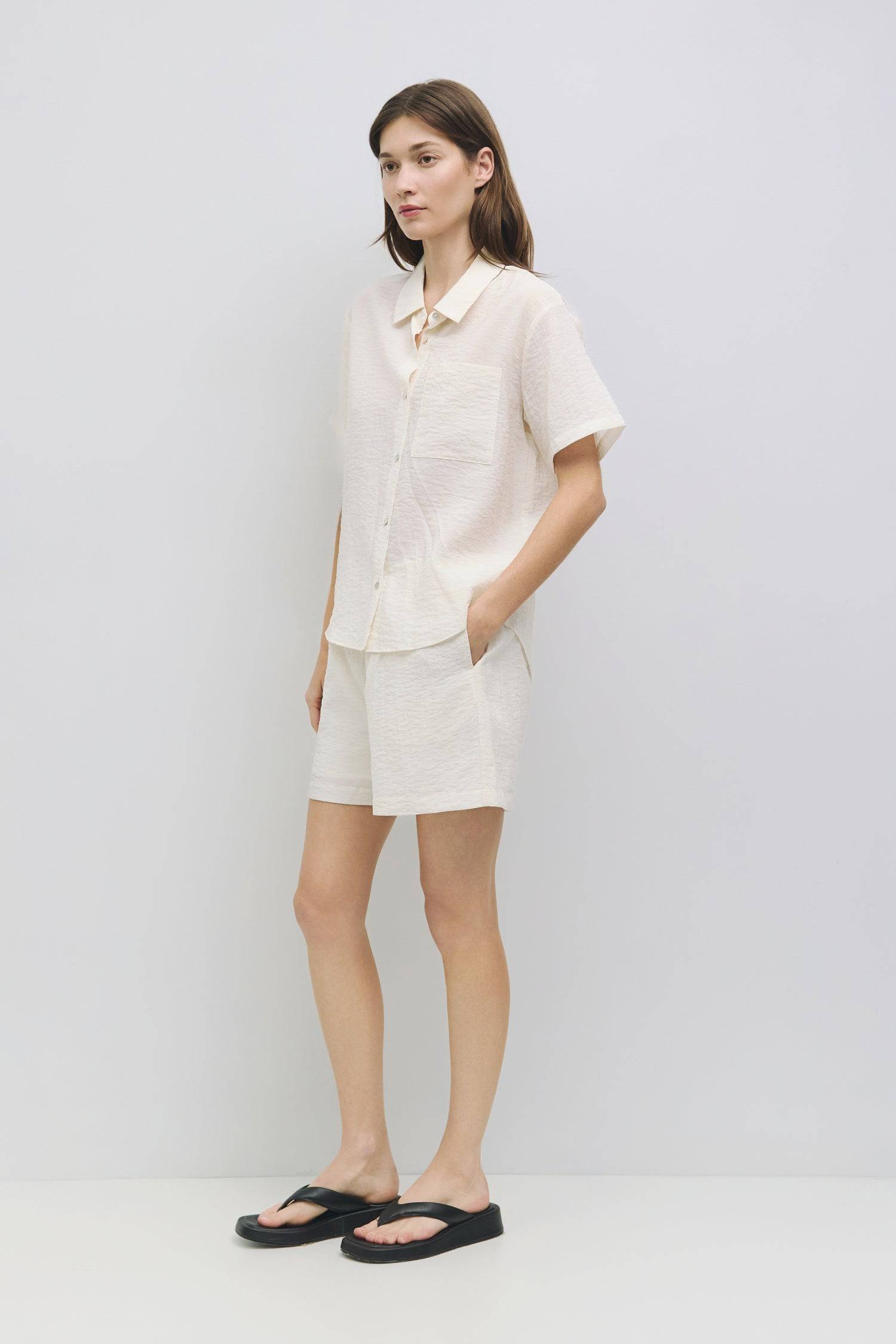 8954054279389, The Alden Top, Tops, Mod Ref, Black,Button Up,Casual,cf-color-black,cf-color-cream,cf-size-l,cf-size-m,cf-size-s,cf-vendor-all-row,cinched,Cream,Cropped,cropped hemline,final-sale,finalsale,Front Tie,Mod Ref,new,Olive,sale,Short Sleeve,Spring,Summer,white,Women's,womens top, Information The Alden Top is a short-sleeve, button-down shirt with a collar neckline and a shirttail hem, made from a sheer plisse fabric. Pair it with The Alden Shorts (PR2381) for a relaxed yet put-together look. Detai