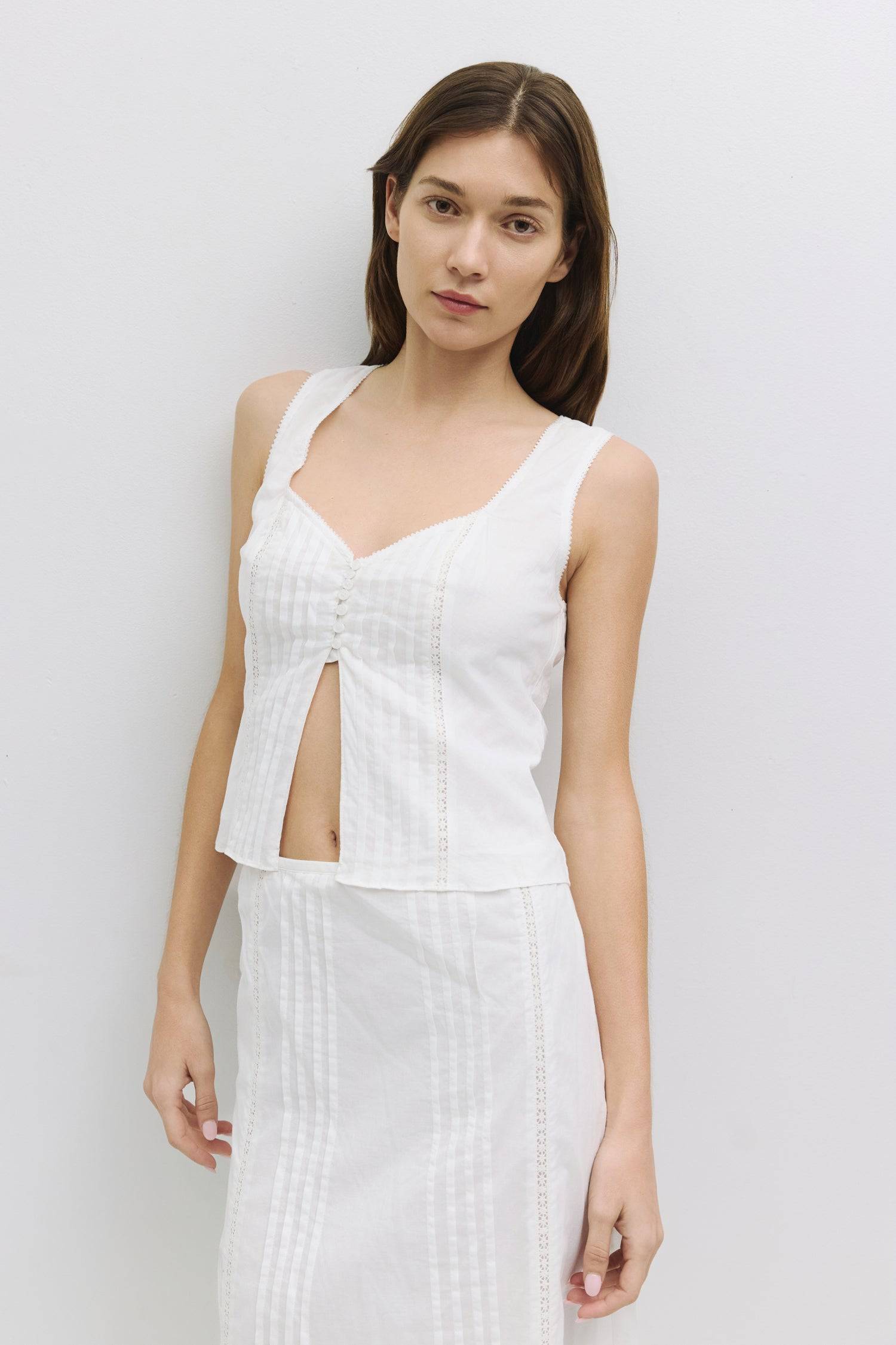 8954054246621, The Finley Top, Tops, Mod Ref, Black,brown,Casual,cf-color-brown,cf-color-white,cf-size-l,cf-size-m,cf-size-s,cf-vendor-all-row,cinched,Cinched Waist,Cropped,cropped hemline,Feminine,final-sale,finalsale,Matching Set,Mod Ref,new,sale,set,Sets,Short Sleeve,Sleeveless Top,Spring,Summer,V Neckline,white,Women's,womens top, Information The Finley Top is a sleeveless cotton blouse with a sweetheart neckline, a partial button-down front, and delicate pleat details. It features a lace inset on the f