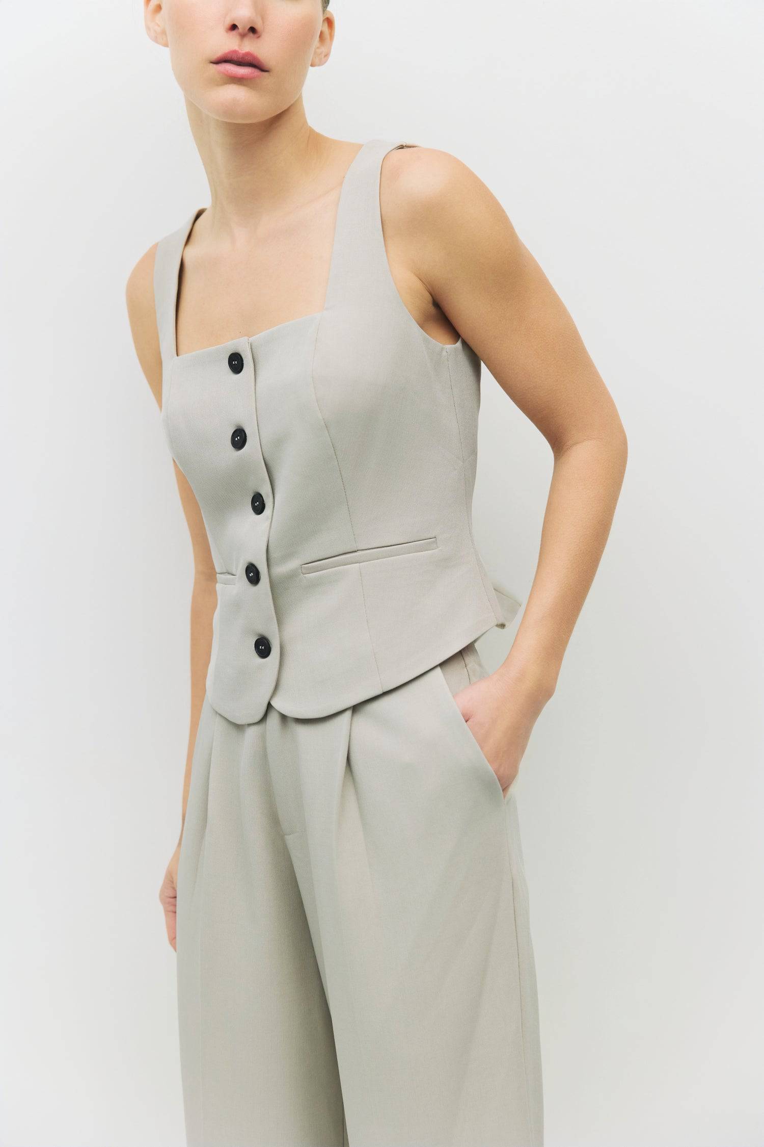 8994993275101, The Nichole Top, Tops, Mod Ref, beige,Button down,cf-color-beige,cf-color-blue,cf-size-l,cf-size-m,cf-size-s,cf-vendor-mod-ref,Cotton,everyday,new,spring,Striped,Summer,Tops,Transitional,Vest,Vest Top,womens,Work,Workwear, Information The Nichole Top is a sleeveless square-neck vest with a fitted silhouette and a sleek front button closure. Featuring two front welt pockets, it pairs perfectly with the matching Nichole Pants (PR2404) for a complete, refined look. Details Self: 95% Polyester, 5