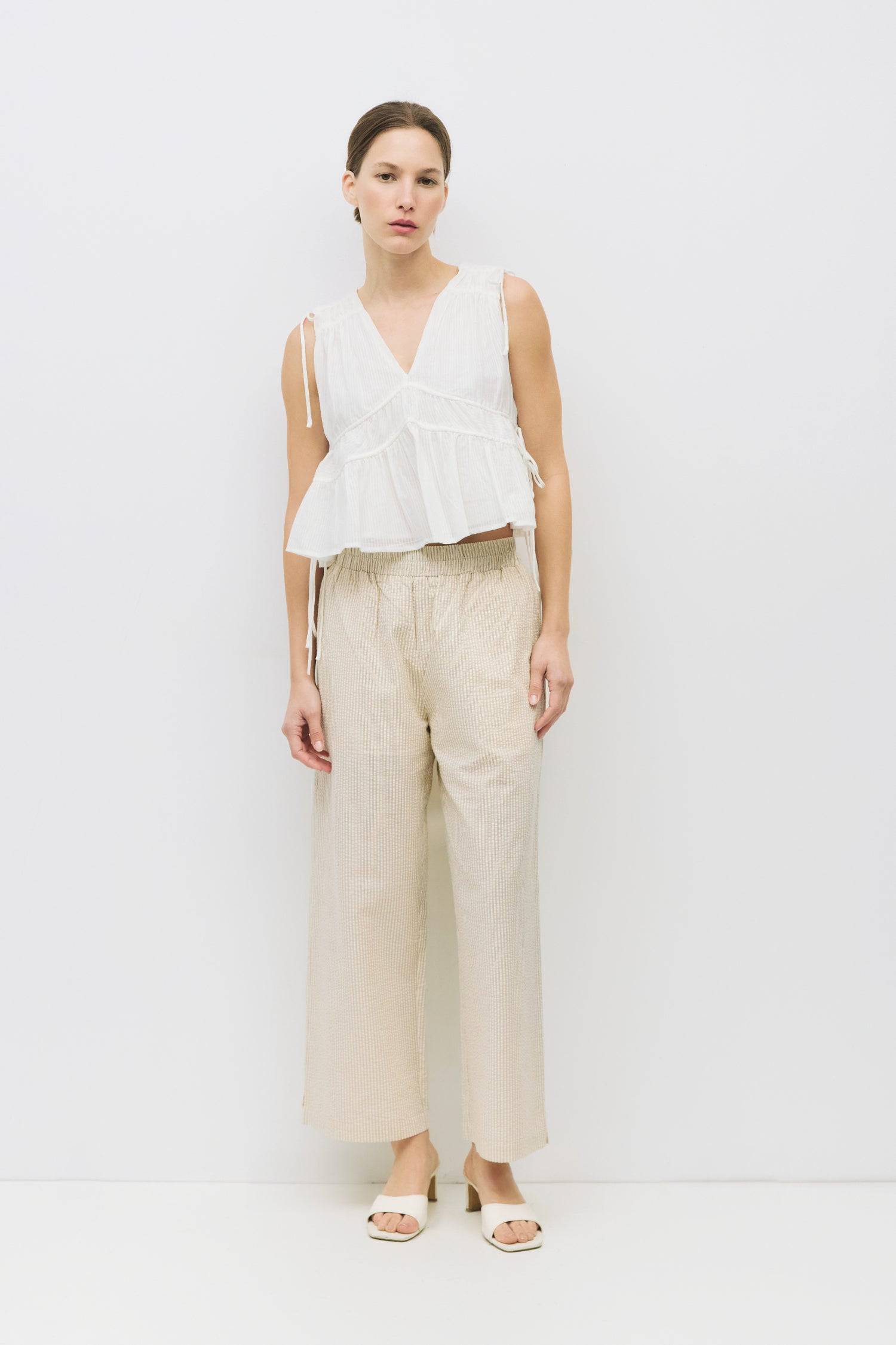 8983747625181, The Ellice Top, Tops, Mod Ref, Black,Breathable,Button down,Button Down Shirt,Button Up,Casual,cf-color-black,cf-color-blue,cf-color-white,cf-size-l,cf-size-m,cf-size-s,cf-vendor-mod-ref,cinched,Cinched Back,Cinched Waist,collared,Collared Top,Cotton,everyday,final-sale,finalsale,Long Sleeve,Long Sleeve Top,new,Oversized,sale,spring,Striped,Summer,Tops,Transitional,white,womens,Work,Workwear, Information The Ellice Top is a cropped, tiered, and sleeveless top with side adjustable ties. Featur