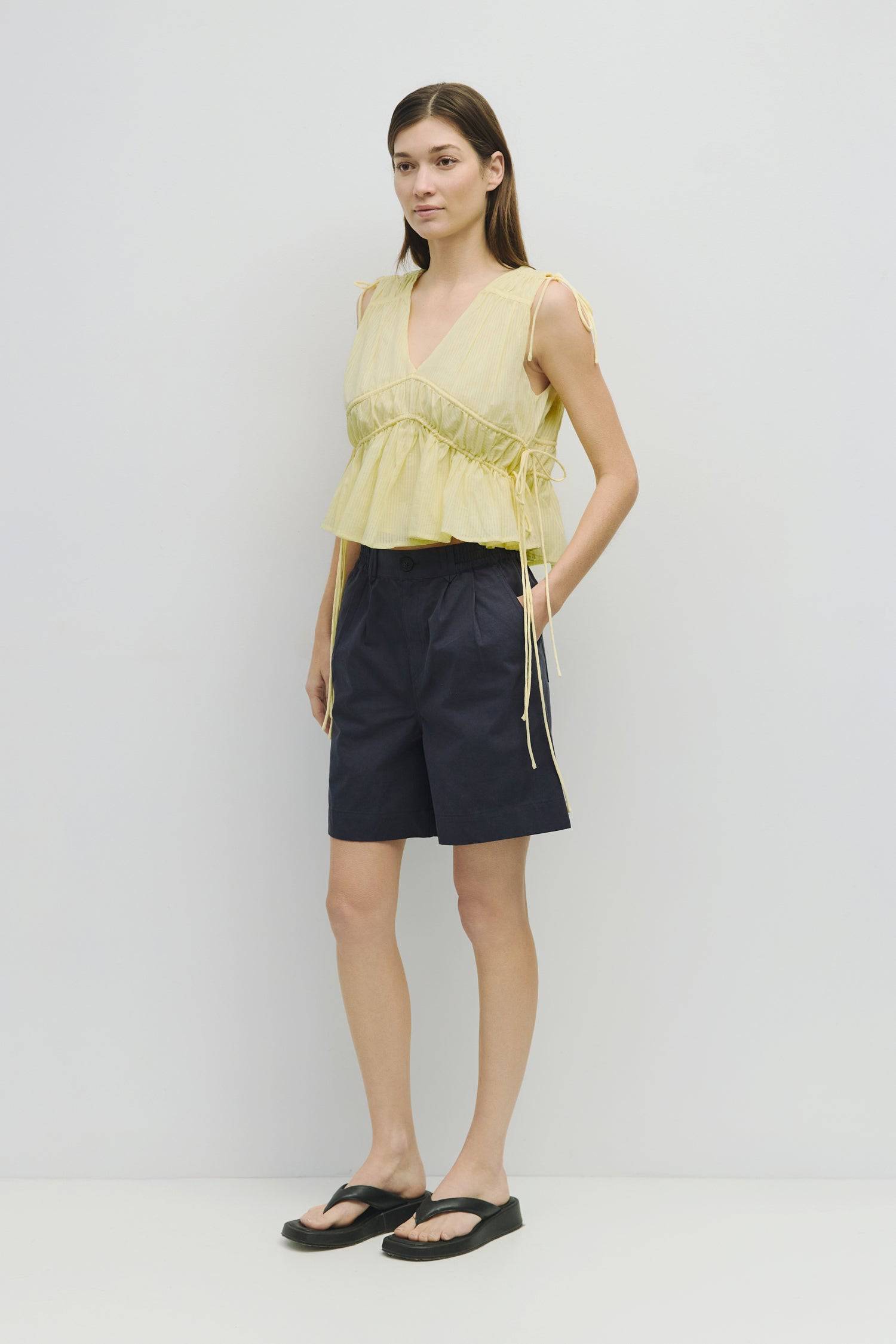 8983747625181, The Ellice Top, Tops, Mod Ref, Black,Breathable,Button down,Button Down Shirt,Button Up,Casual,cf-color-black,cf-color-blue,cf-color-white,cf-size-l,cf-size-m,cf-size-s,cf-vendor-mod-ref,cinched,Cinched Back,Cinched Waist,collared,Collared Top,Cotton,everyday,final-sale,finalsale,Long Sleeve,Long Sleeve Top,new,Oversized,sale,spring,Striped,Summer,Tops,Transitional,white,womens,Work,Workwear, Information The Ellice Top is a cropped, tiered, and sleeveless top with side adjustable ties. Featur