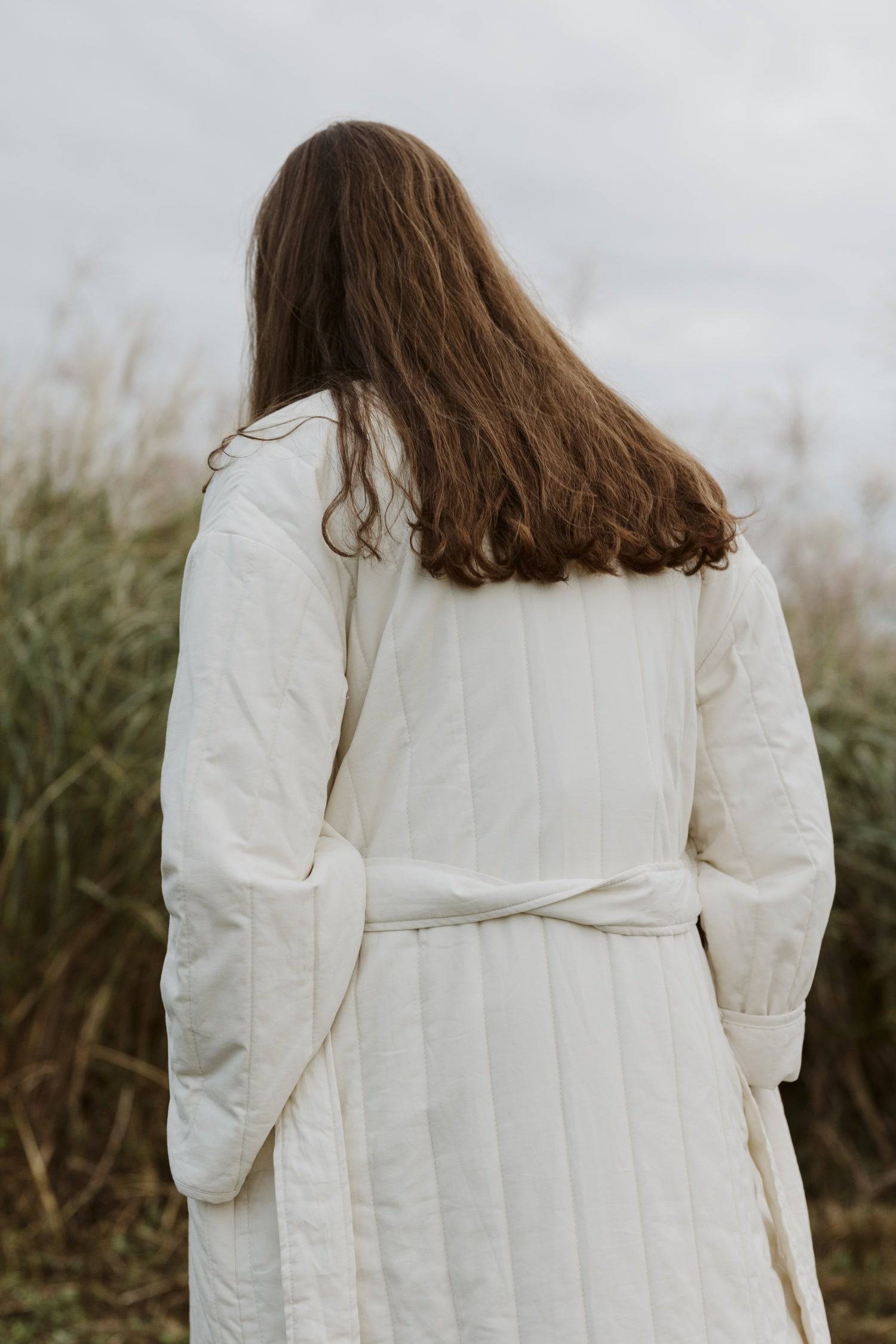 7964146401501, The Cary Coat, Outerwear, All Row, All Row,allrow,Back Detail,cf-color-black,cf-color-cream,cf-size-l,cf-size-m,cf-size-s,cf-vendor-all-row,Coat,Cotton,Cream,Detail,final-sale,finalsale,minimalist,new,Oversized,sale,statement,statement piece,tencel,Womens,womens top, Information Your winter wardrobe won't be complete without this long quilted coat. The Cary Coat is made in an oversized fit and features a classic rounded neckline, a button front closure, patch pockets, an easy below-the-knee l