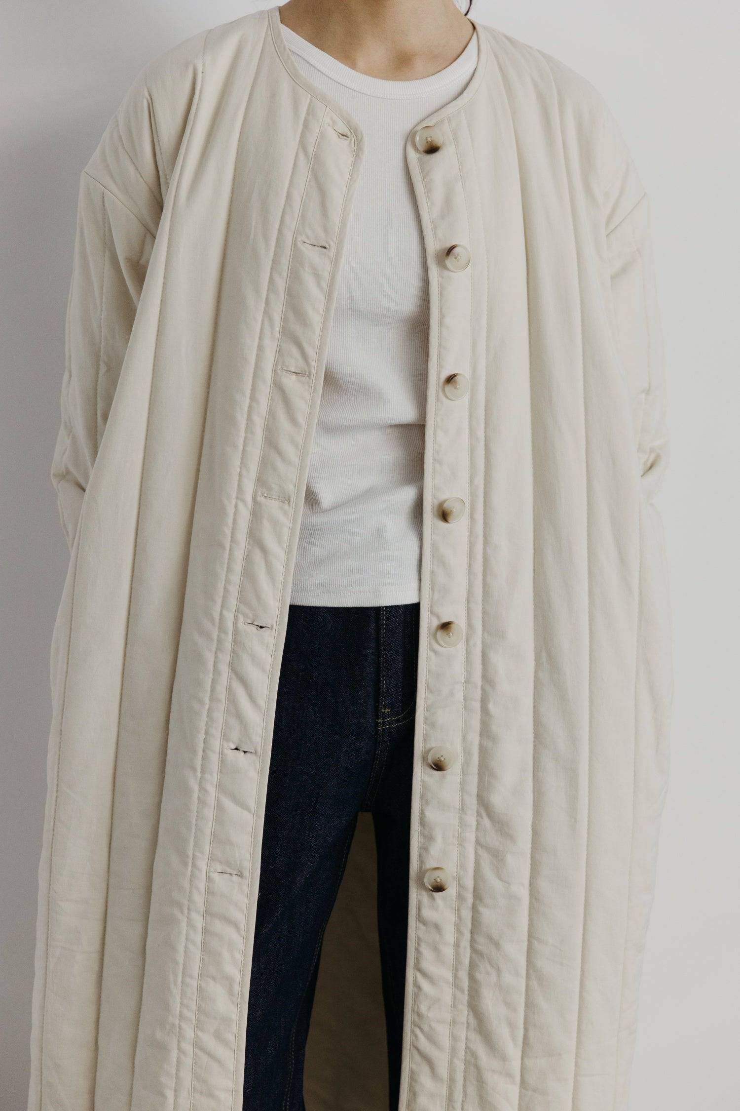 7964146401501, The Cary Coat, Outerwear, All Row, All Row,allrow,Back Detail,cf-color-black,cf-color-cream,cf-size-l,cf-size-m,cf-size-s,cf-vendor-all-row,Coat,Cotton,Cream,Detail,final-sale,finalsale,minimalist,new,Oversized,sale,statement,statement piece,tencel,Womens,womens top, Information Your winter wardrobe won't be complete without this long quilted coat. The Cary Coat is made in an oversized fit and features a classic rounded neckline, a button front closure, patch pockets, an easy below-the-knee l