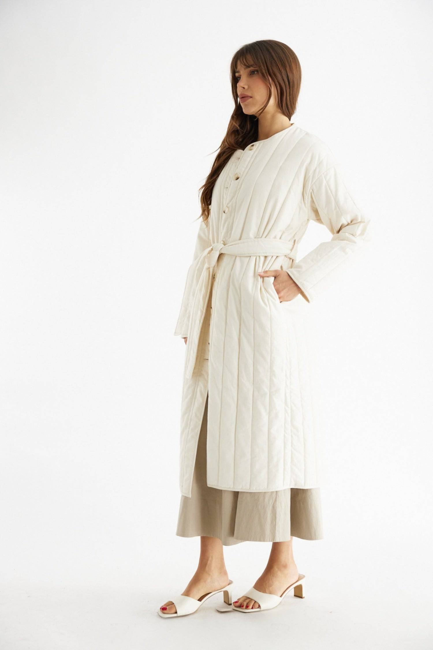 7964146401501, The Cary Coat, Outerwear, All Row, All Row,allrow,Back Detail,cf-color-black,cf-color-cream,cf-size-l,cf-size-m,cf-size-s,cf-vendor-all-row,Coat,Cotton,Cream,Detail,final-sale,finalsale,minimalist,new,Oversized,sale,statement,statement piece,tencel,Womens,womens top, Information Your winter wardrobe won't be complete without this long quilted coat. The Cary Coat is made in an oversized fit and features a classic rounded neckline, a button front closure, patch pockets, an easy below-the-knee l