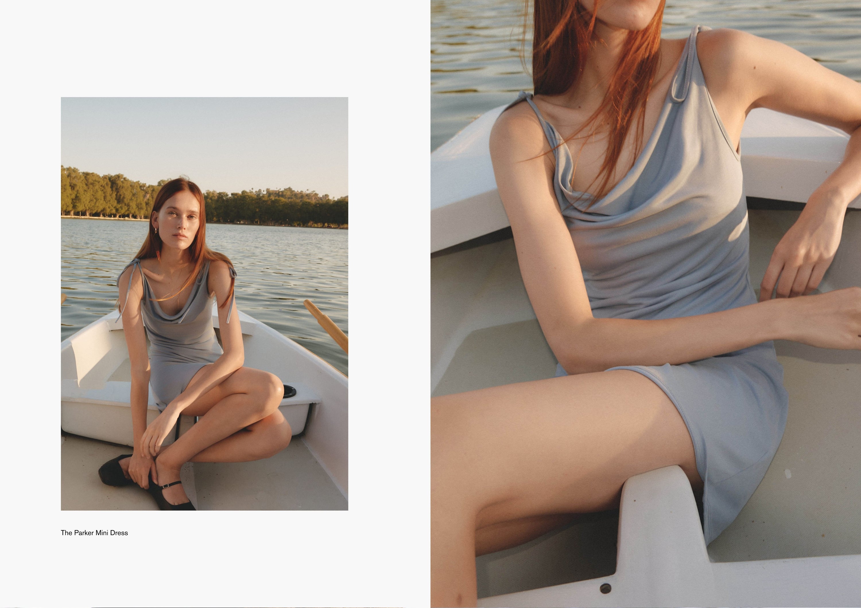 Woman seated casually in a white boat wearing a light blue ribbed dress. Her expression is soft and unposed, capturing a candid summer moment.