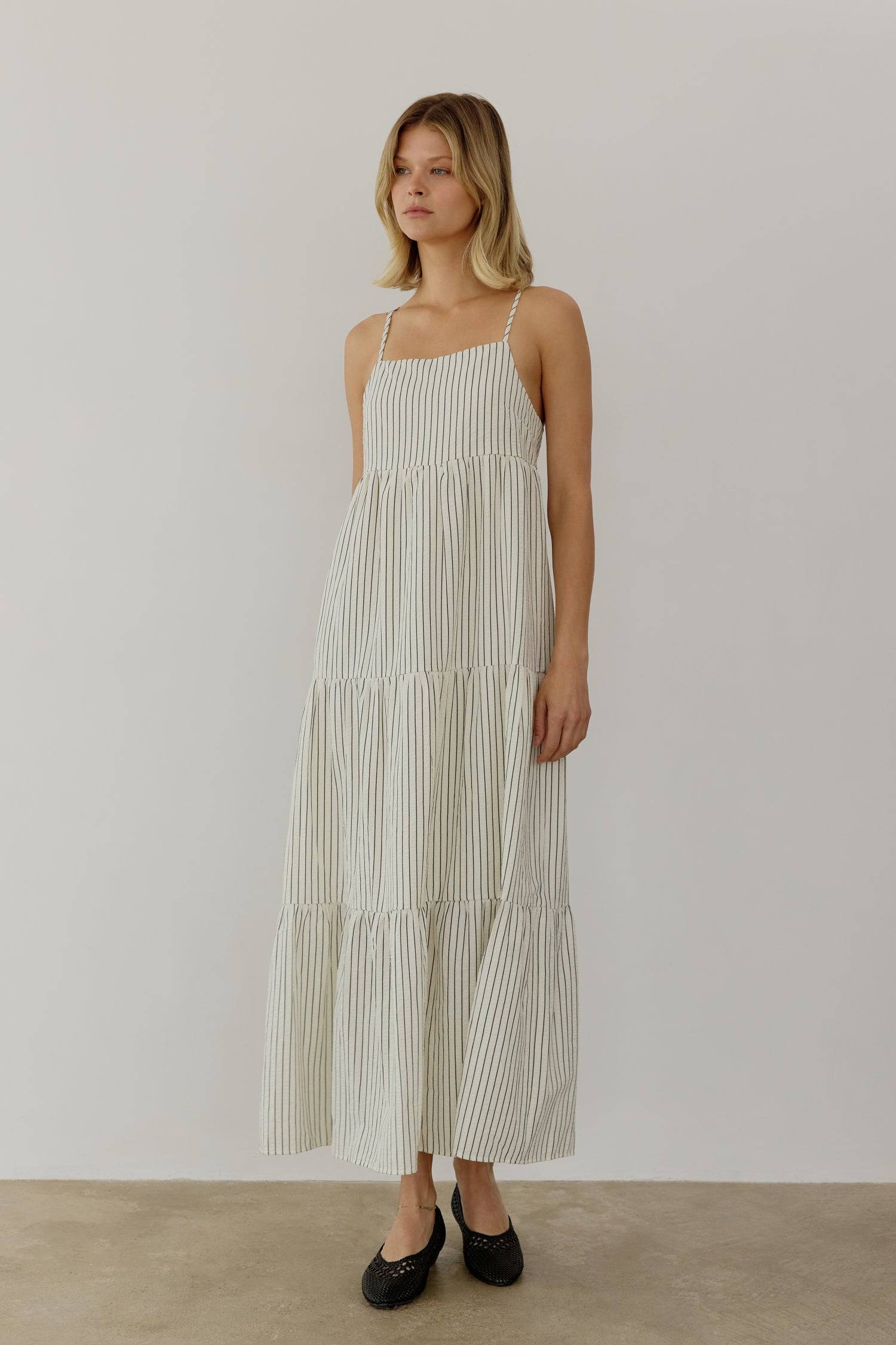 8668654895325, The Aspen Dress, Dress, All Row, adjustable straps,Casual,cf-color-cream,cf-size-l,cf-vendor-all-row,Comfort,Comfortable,Cream,Dress,Feminine,full skirt,Midi,Midi Dress,midi length,new,open back,Pinstripes,Pockets,Semi-Formal,Sleeveless,Sleeveless Dress,Spring,Stripe,Striped,Stripes,Summer,Tiered Dress,versatile,Warm,warm weather,Womens, Information The Aspen Dress is a striped seersucker tiered midi dress that features a square neckline, adjustable shoulder straps, and a back tie detail for 