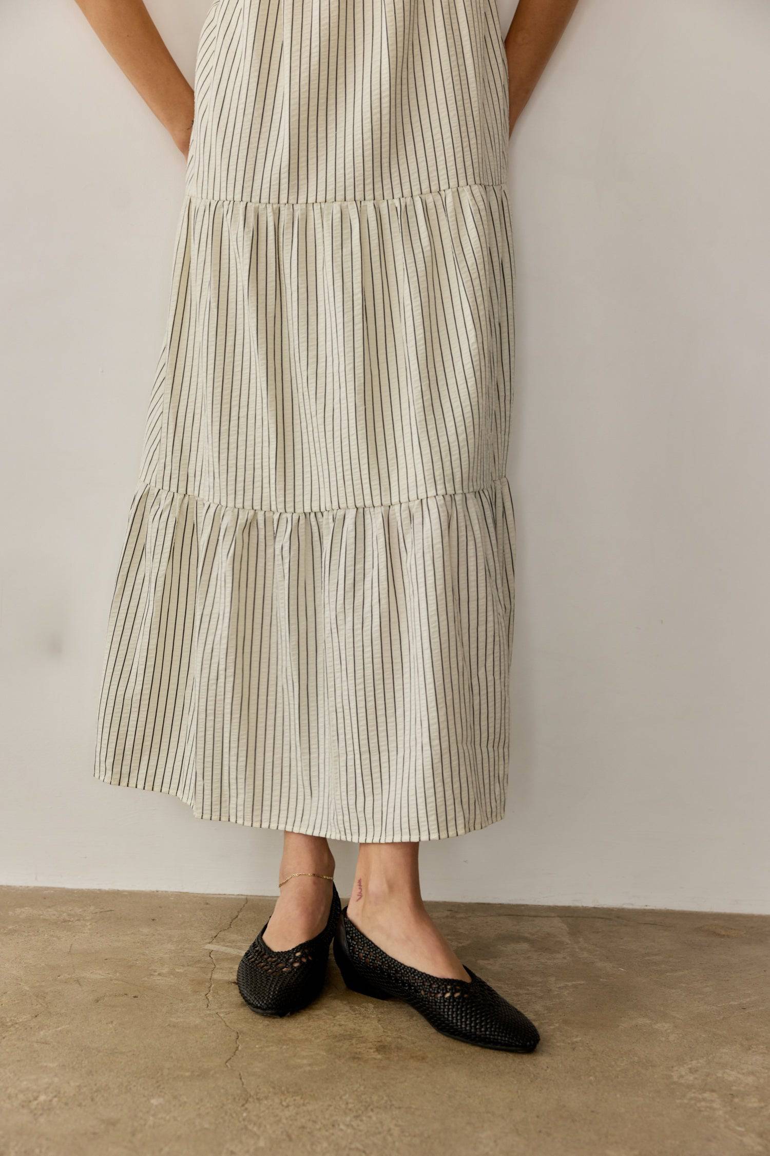 8668654895325, The Aspen Dress, Dress, All Row, adjustable straps,Casual,cf-color-cream,cf-size-l,cf-vendor-all-row,Comfort,Comfortable,Cream,Dress,Feminine,full skirt,Midi,Midi Dress,midi length,new,open back,Pinstripes,Pockets,Semi-Formal,Sleeveless,Sleeveless Dress,Spring,Stripe,Striped,Stripes,Summer,Tiered Dress,versatile,Warm,warm weather,Womens, Information The Aspen Dress is a striped seersucker tiered midi dress that features a square neckline, adjustable shoulder straps, and a back tie detail for 