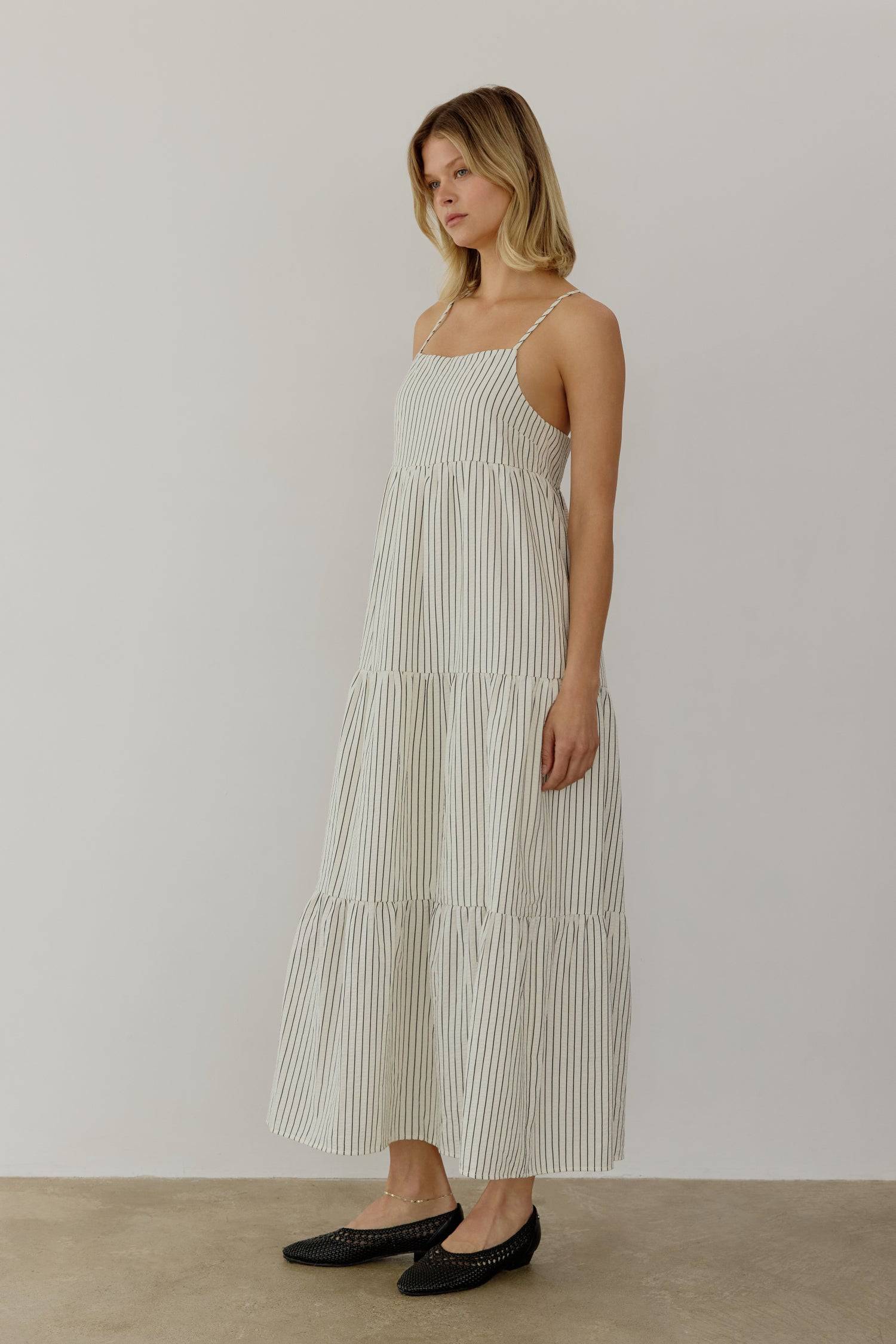 8668654895325, The Aspen Dress, Dress, All Row, adjustable straps,Casual,cf-color-cream,cf-size-l,cf-vendor-all-row,Comfort,Comfortable,Cream,Dress,Feminine,full skirt,Midi,Midi Dress,midi length,new,open back,Pinstripes,Pockets,Semi-Formal,Sleeveless,Sleeveless Dress,Spring,Stripe,Striped,Stripes,Summer,Tiered Dress,versatile,Warm,warm weather,Womens, Information The Aspen Dress is a striped seersucker tiered midi dress that features a square neckline, adjustable shoulder straps, and a back tie detail for 