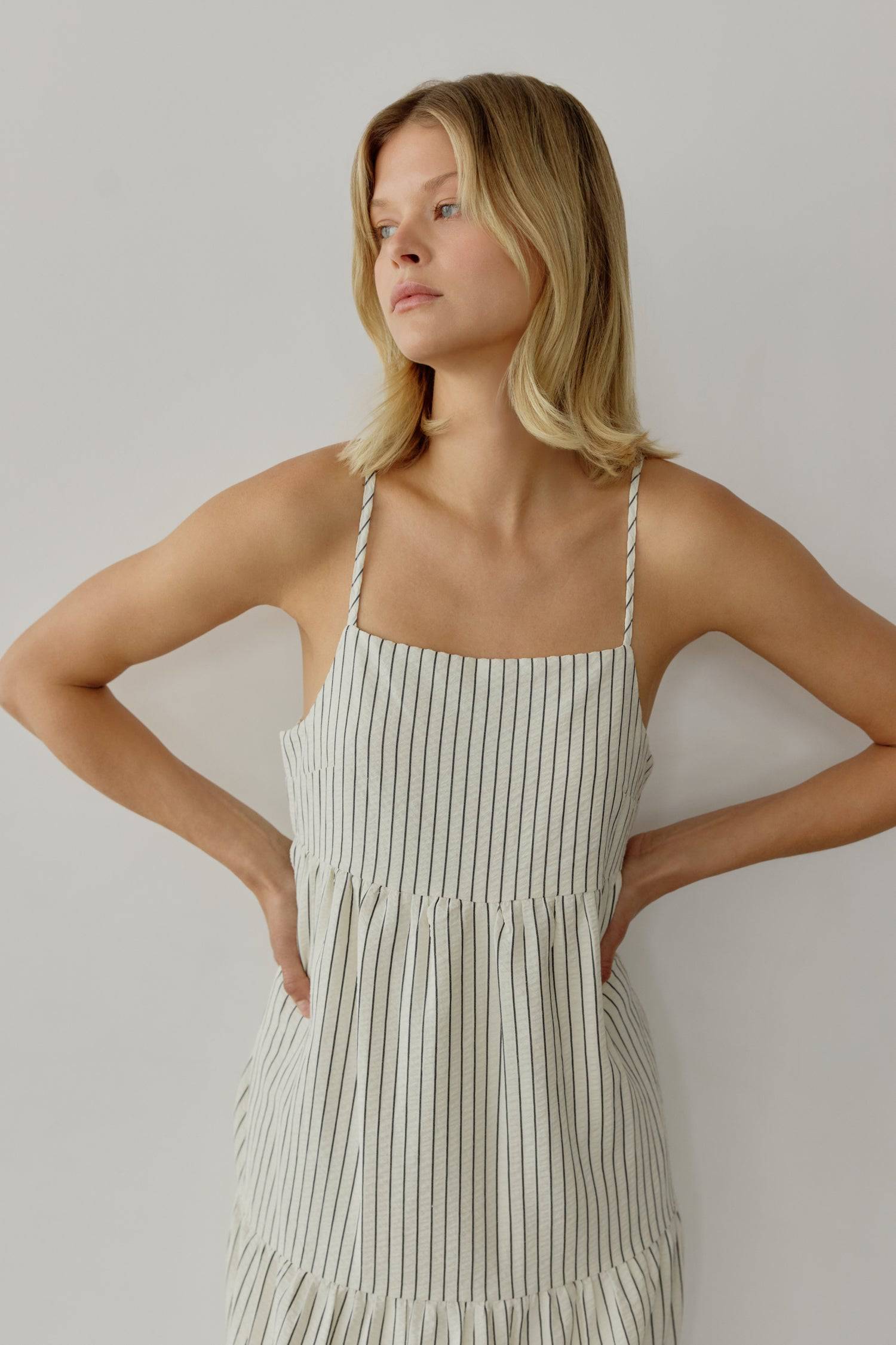 8668654895325, The Aspen Dress, Dress, All Row, adjustable straps,Casual,cf-color-cream,cf-size-l,cf-vendor-all-row,Comfort,Comfortable,Cream,Dress,Feminine,full skirt,Midi,Midi Dress,midi length,new,open back,Pinstripes,Pockets,Semi-Formal,Sleeveless,Sleeveless Dress,Spring,Stripe,Striped,Stripes,Summer,Tiered Dress,versatile,Warm,warm weather,Womens, Information The Aspen Dress is a striped seersucker tiered midi dress that features a square neckline, adjustable shoulder straps, and a back tie detail for 