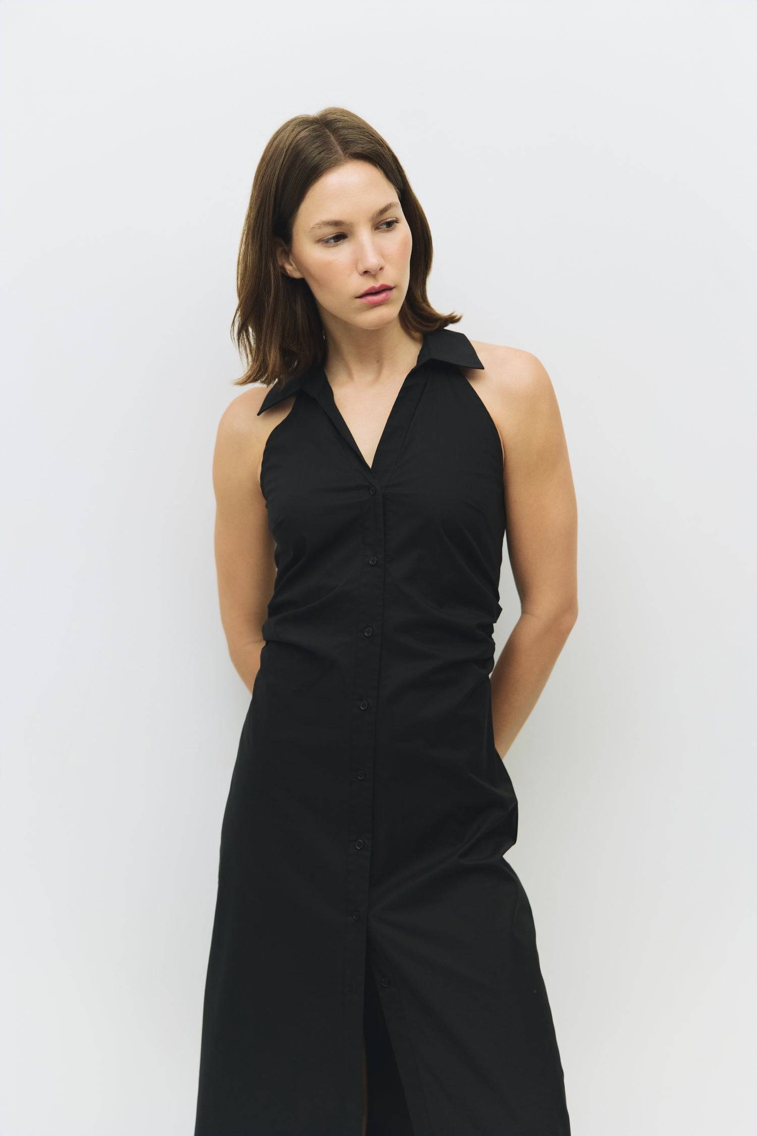 8983745003741, The Cambria Dress, Dress, Mod Ref, Black,Casual,cf-color-black,cf-color-red,cf-color-white,cf-size-l,cf-vendor-all-row,collared,Comfort,Comfortable,Feminine,full skirt,Midi,Midi Dress,midi length,new,Red,Sleeveless,Sleeveless Dress,Spring,versatile,white,Womens, Information The Cambria Dress is a sleeveless, midi-length poplin dress featuring a halter neckline with a collar and a front button placket. With adjustable lace-back ties, it offers a customizable fit and effortless style for warm-w