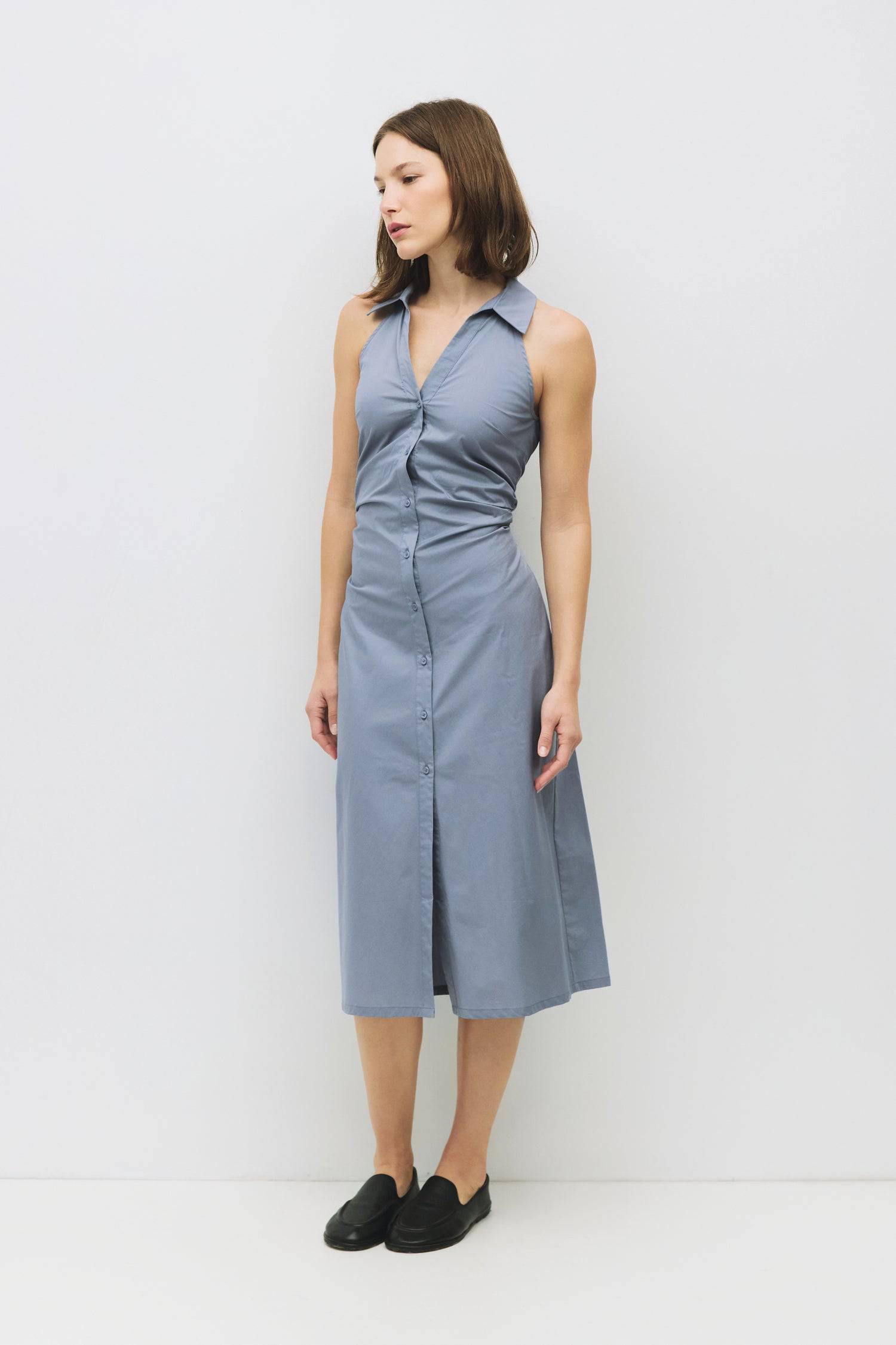 8983745003741, The Cambria Dress, Dress, Mod Ref, Black,Casual,cf-color-black,cf-color-red,cf-color-white,cf-size-l,cf-vendor-all-row,collared,Comfort,Comfortable,Feminine,full skirt,Midi,Midi Dress,midi length,new,Red,Sleeveless,Sleeveless Dress,Spring,versatile,white,Womens, Information The Cambria Dress is a sleeveless, midi-length poplin dress featuring a halter neckline with a collar and a front button placket. With adjustable lace-back ties, it offers a customizable fit and effortless style for warm-w