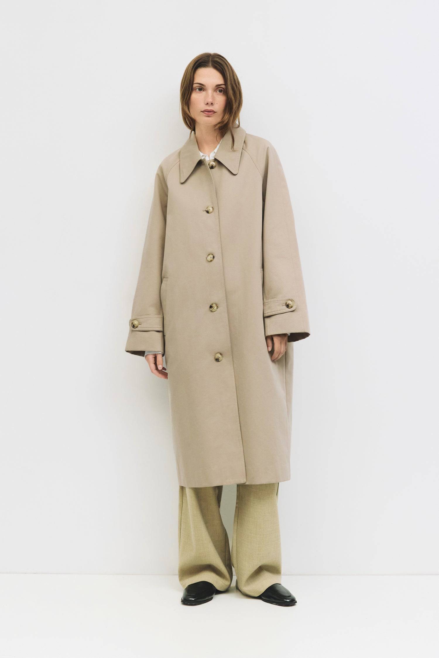9045717582045, The Serena Coat, Outerwear, Mod Ref, beige,cf-color-beige,cf-color-olive,cf-size-l,cf-size-m,cf-size-s,cf-vendor-mod-ref,Coat,coat jacket,Comfort,Comfortable,Detail,Details,Fall,layer,layering,Layers,Long,Long Sleeve,midi length,modref,new,Olive,Outerwear,Oversized,Oversized Coat,Peacoat,Pockets,scarf,Spring,Summer,Transitional,Trench,Trench Coat,Womens, Information The Serena Coat blends timeless tailoring with contemporary ease, featuring a pointed collar and raglan sleeves for a relaxed ye
