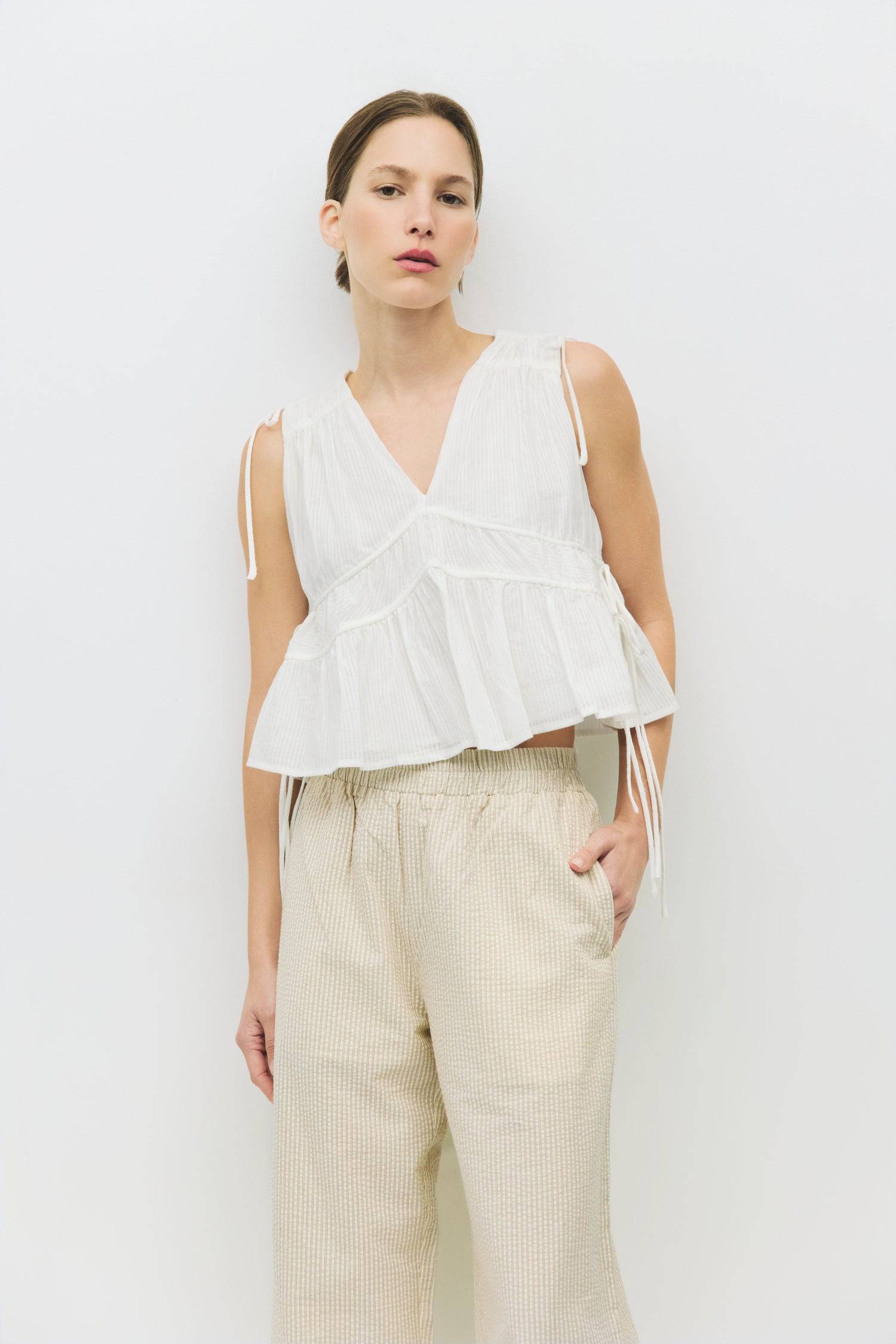 8983747625181, The Ellice Top, Tops, Mod Ref, Black,Breathable,Button down,Button Down Shirt,Button Up,Casual,cf-color-black,cf-color-blue,cf-color-white,cf-size-l,cf-size-m,cf-size-s,cf-vendor-mod-ref,cinched,Cinched Back,Cinched Waist,collared,Collared Top,Cotton,everyday,final-sale,finalsale,Long Sleeve,Long Sleeve Top,new,Oversized,sale,spring,Striped,Summer,Tops,Transitional,white,womens,Work,Workwear, Information The Ellice Top is a cropped, tiered, and sleeveless top with side adjustable ties. Featur