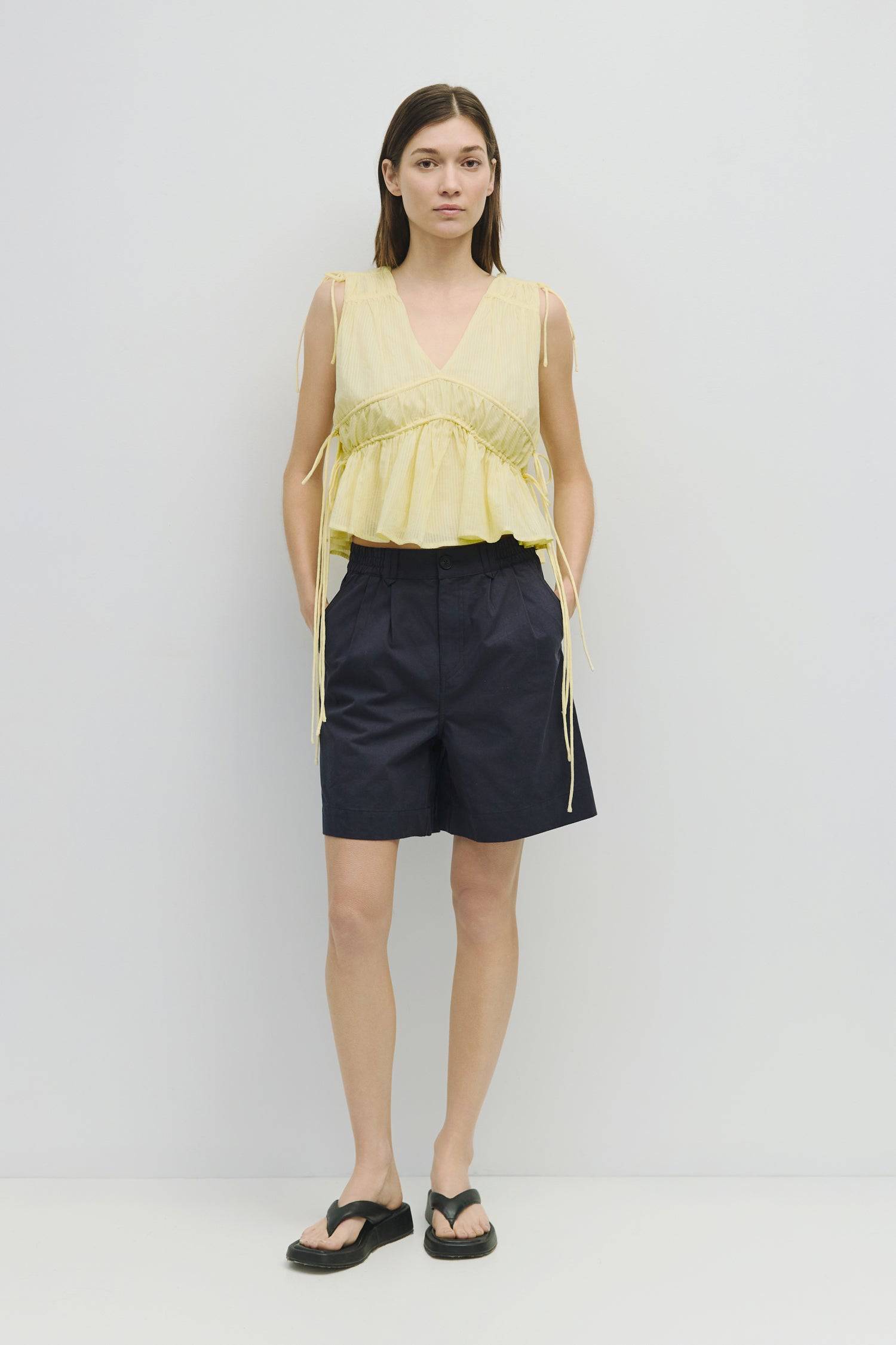 8983747625181, The Ellice Top, Tops, Mod Ref, Black,Breathable,Button down,Button Down Shirt,Button Up,Casual,cf-color-black,cf-color-blue,cf-color-white,cf-size-l,cf-size-m,cf-size-s,cf-vendor-mod-ref,cinched,Cinched Back,Cinched Waist,collared,Collared Top,Cotton,everyday,final-sale,finalsale,Long Sleeve,Long Sleeve Top,new,Oversized,sale,spring,Striped,Summer,Tops,Transitional,white,womens,Work,Workwear, Information The Ellice Top is a cropped, tiered, and sleeveless top with side adjustable ties. Featur