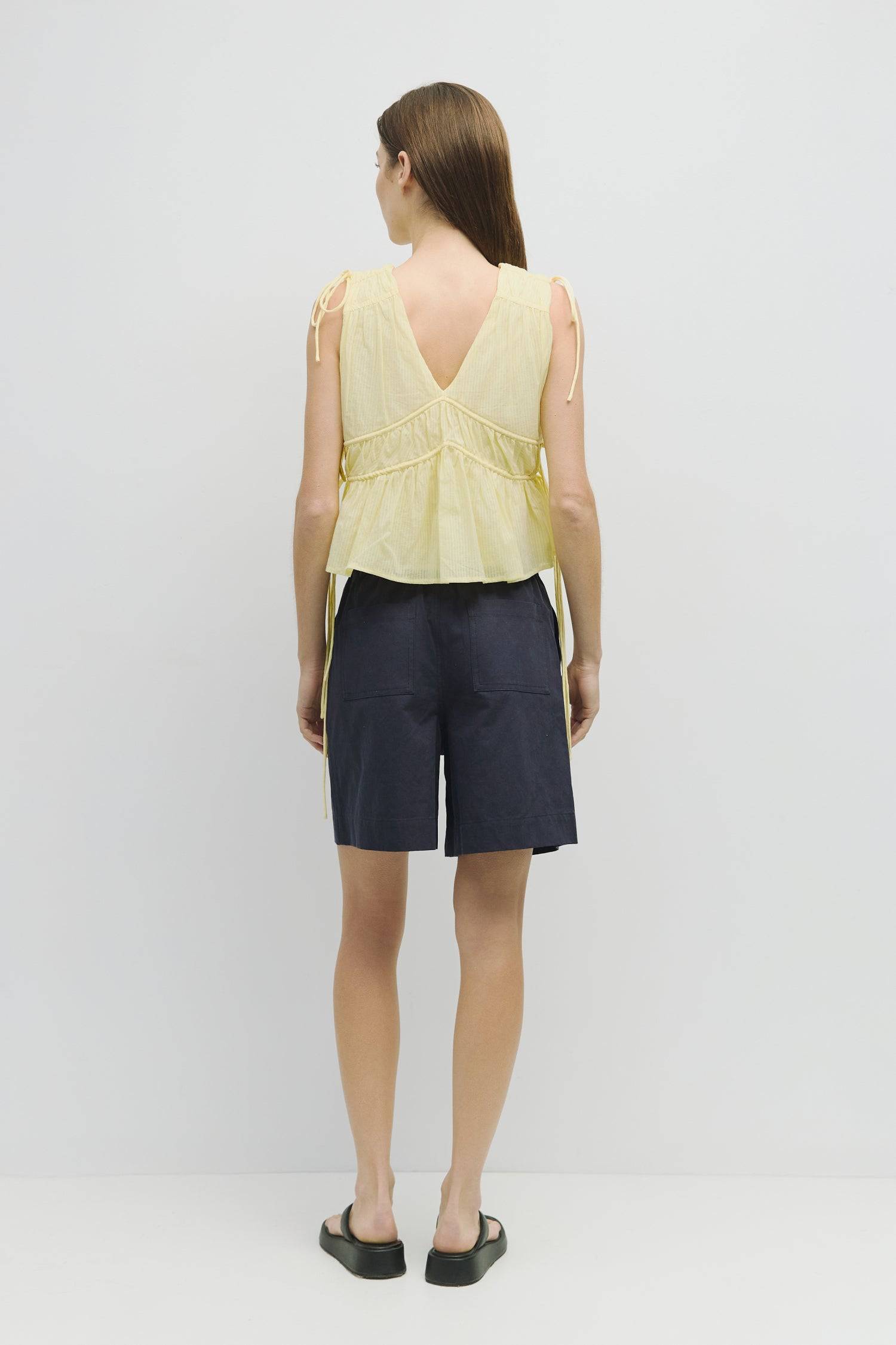 8983747625181, The Ellice Top, Tops, Mod Ref, Black,Breathable,Button down,Button Down Shirt,Button Up,Casual,cf-color-black,cf-color-blue,cf-color-white,cf-size-l,cf-size-m,cf-size-s,cf-vendor-mod-ref,cinched,Cinched Back,Cinched Waist,collared,Collared Top,Cotton,everyday,final-sale,finalsale,Long Sleeve,Long Sleeve Top,new,Oversized,sale,spring,Striped,Summer,Tops,Transitional,white,womens,Work,Workwear, Information The Ellice Top is a cropped, tiered, and sleeveless top with side adjustable ties. Featur